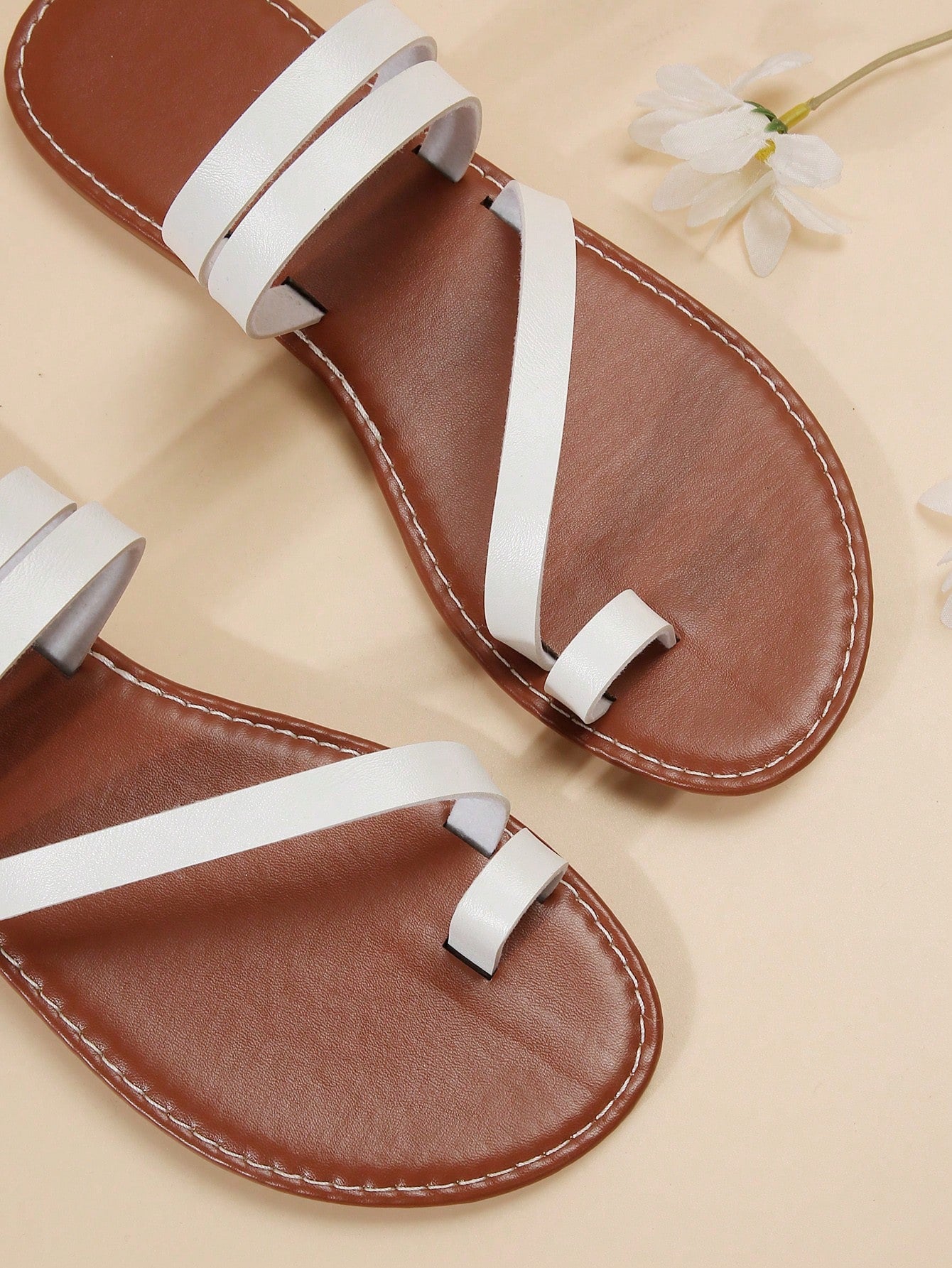 Women's flat slip-on sandal with toe ring and cross-over strappy upper, designed for casual beach and outdoor wear with an anti-slip sole.