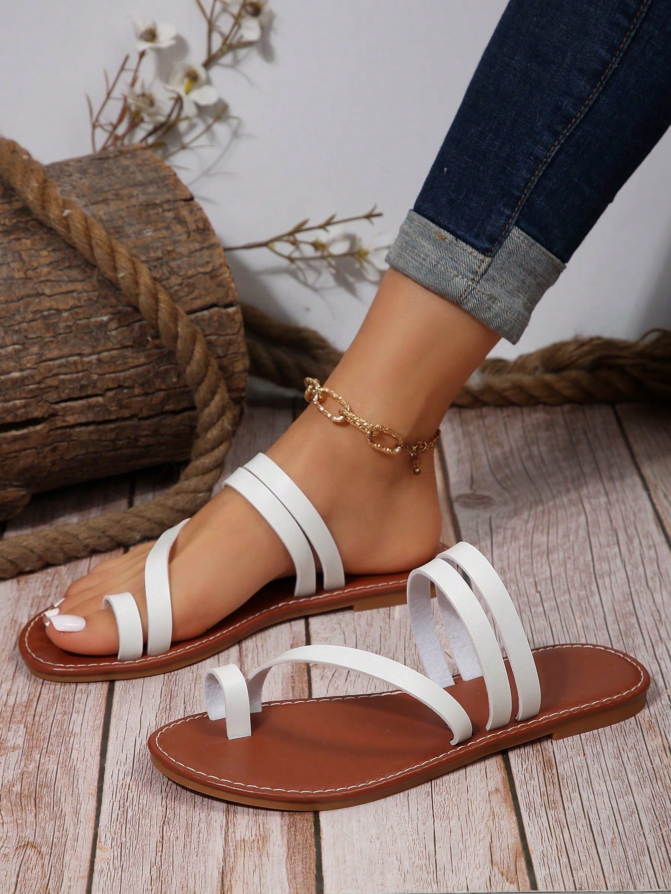 Women's flat slip-on sandal with toe ring and cross-over strappy upper, designed for casual beach and outdoor wear with an anti-slip sole.