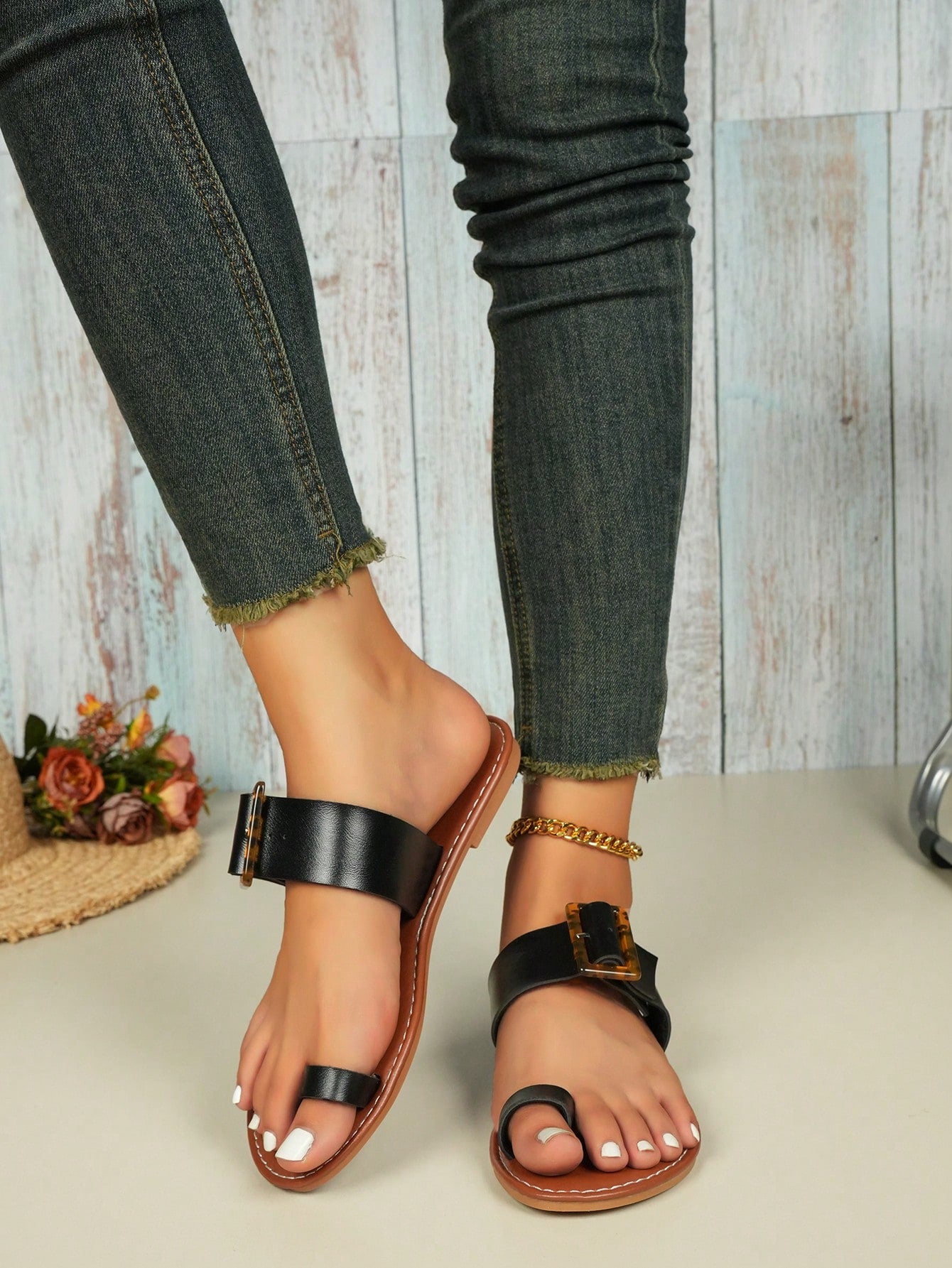Women's flat slide sandals with leopard print styling, antique-style square buckle detail, and toe post design.