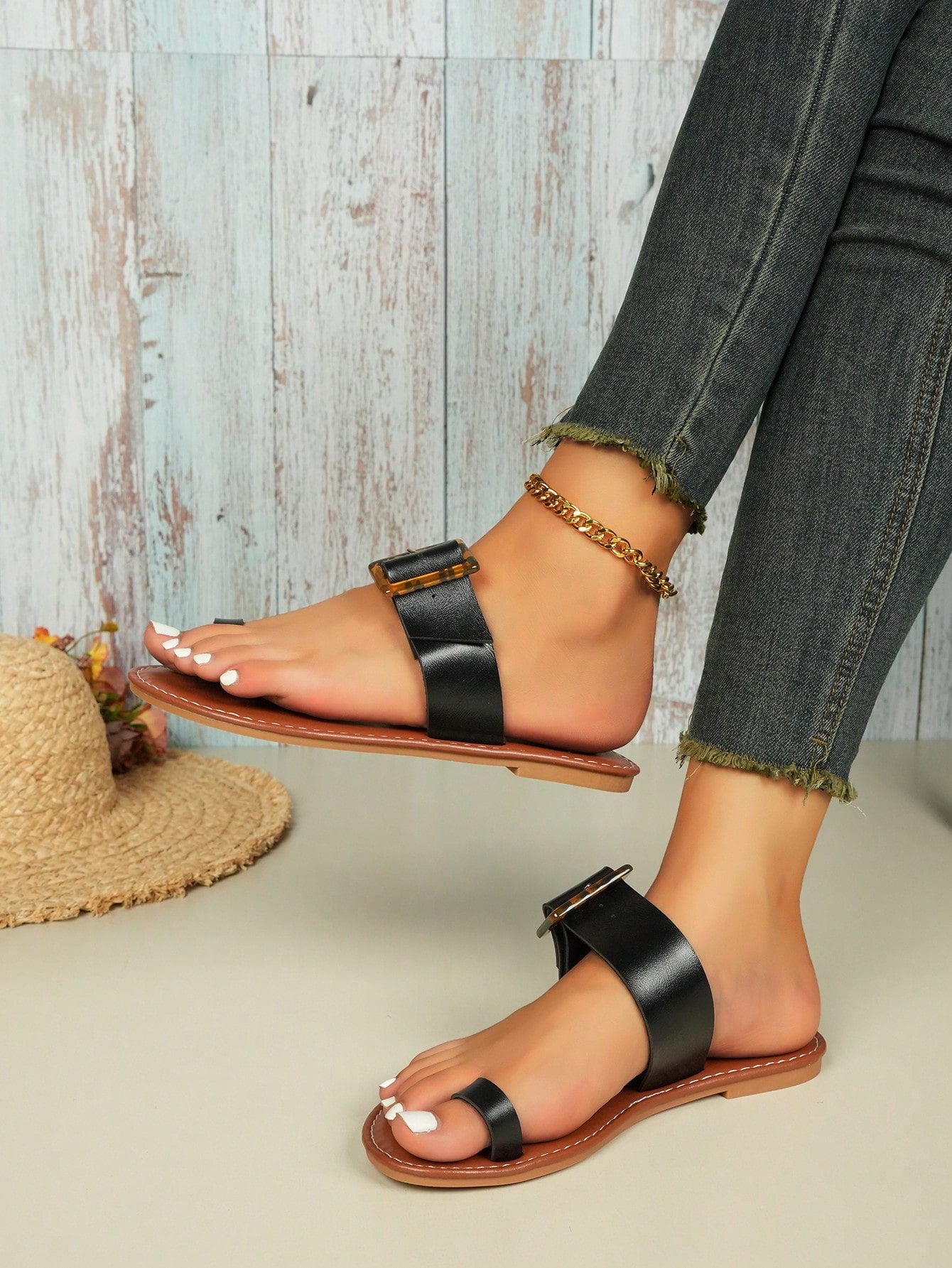 Women's flat slide sandals with leopard print styling, antique-style square buckle detail, and toe post design.