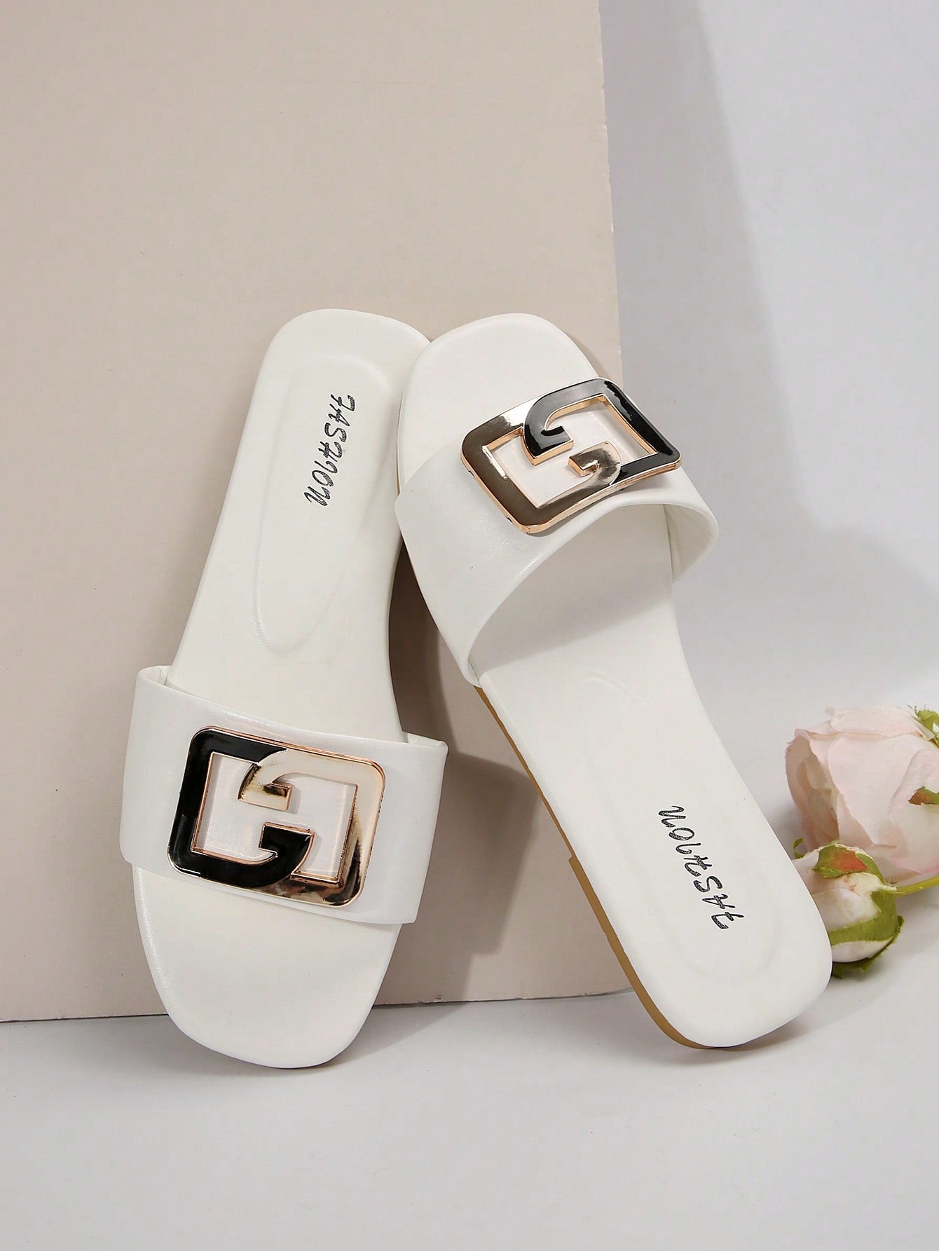 Women's gold-tone slip-on slide sandals with open toe and chain link detailing, shown as casual flat sandals for indoor and outdoor use.