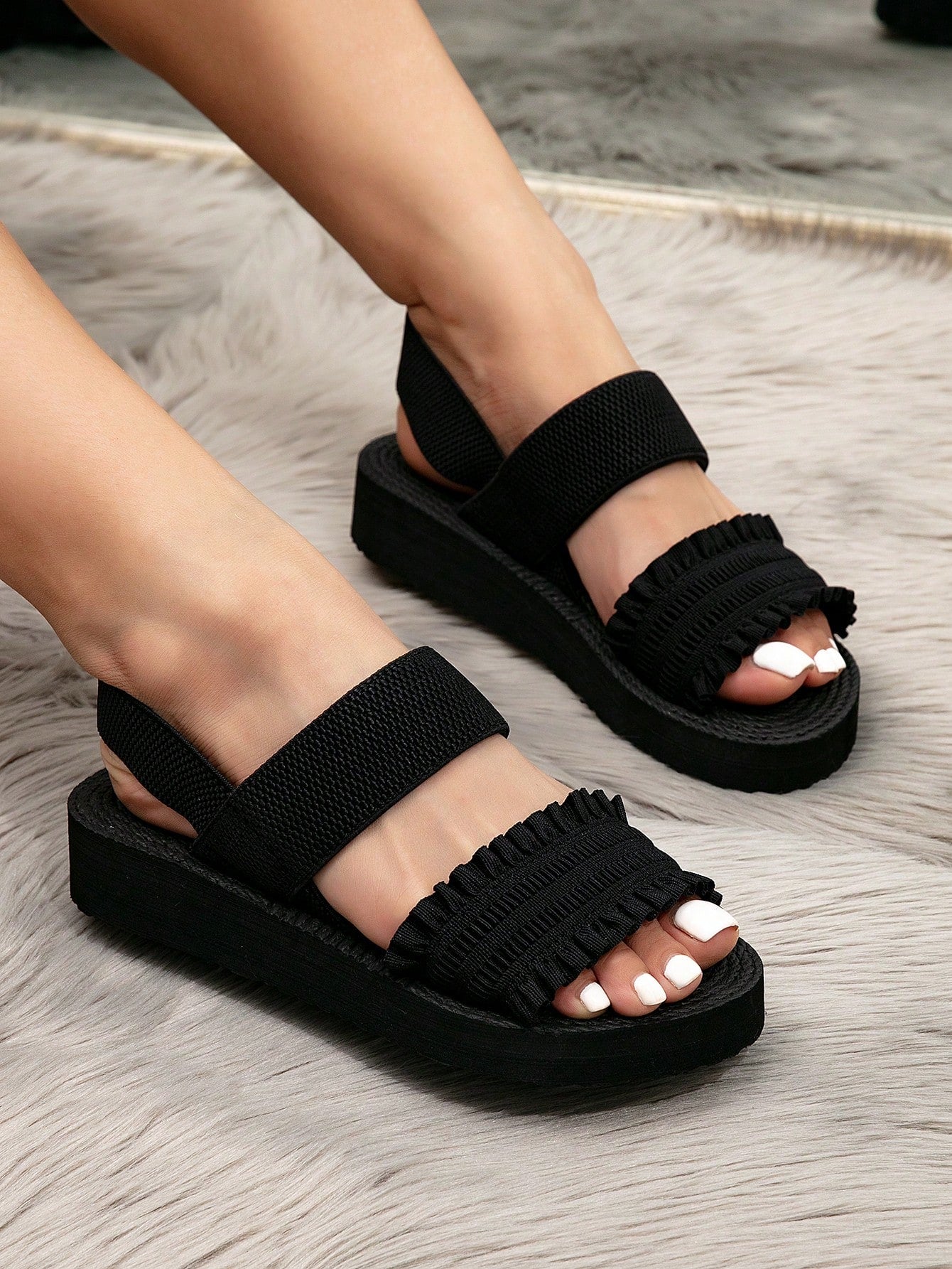 Women's black flat gladiator sandals with ruched and ruffle trim, textured fabric upper, and open-toe design for party, outdoor, and casual wear.