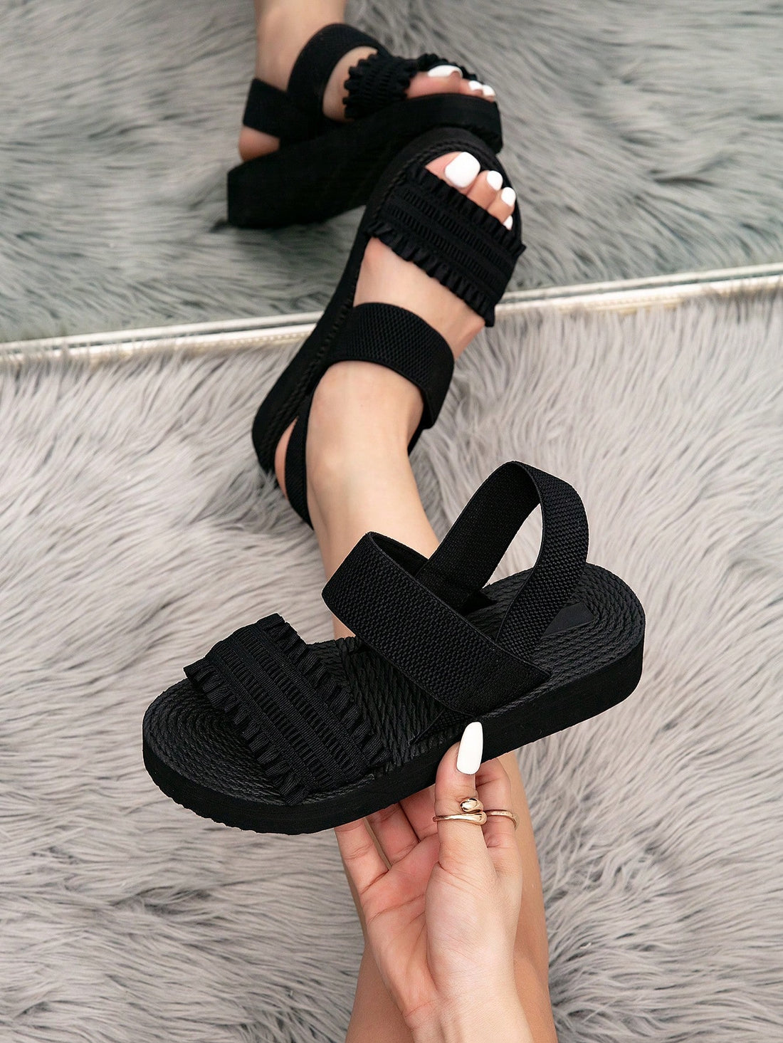 Women's black flat gladiator sandals with ruched and ruffle trim, textured fabric upper, and open-toe design for party, outdoor, and casual wear.