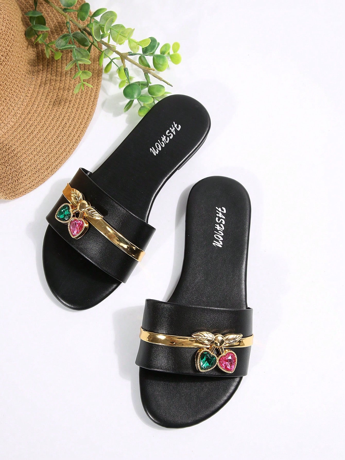 Pair of women's black flat slide sandals featuring rhinestone embellishments, metal accents, and a gold-strip detail on the upper, with an open-toe slip-on design.