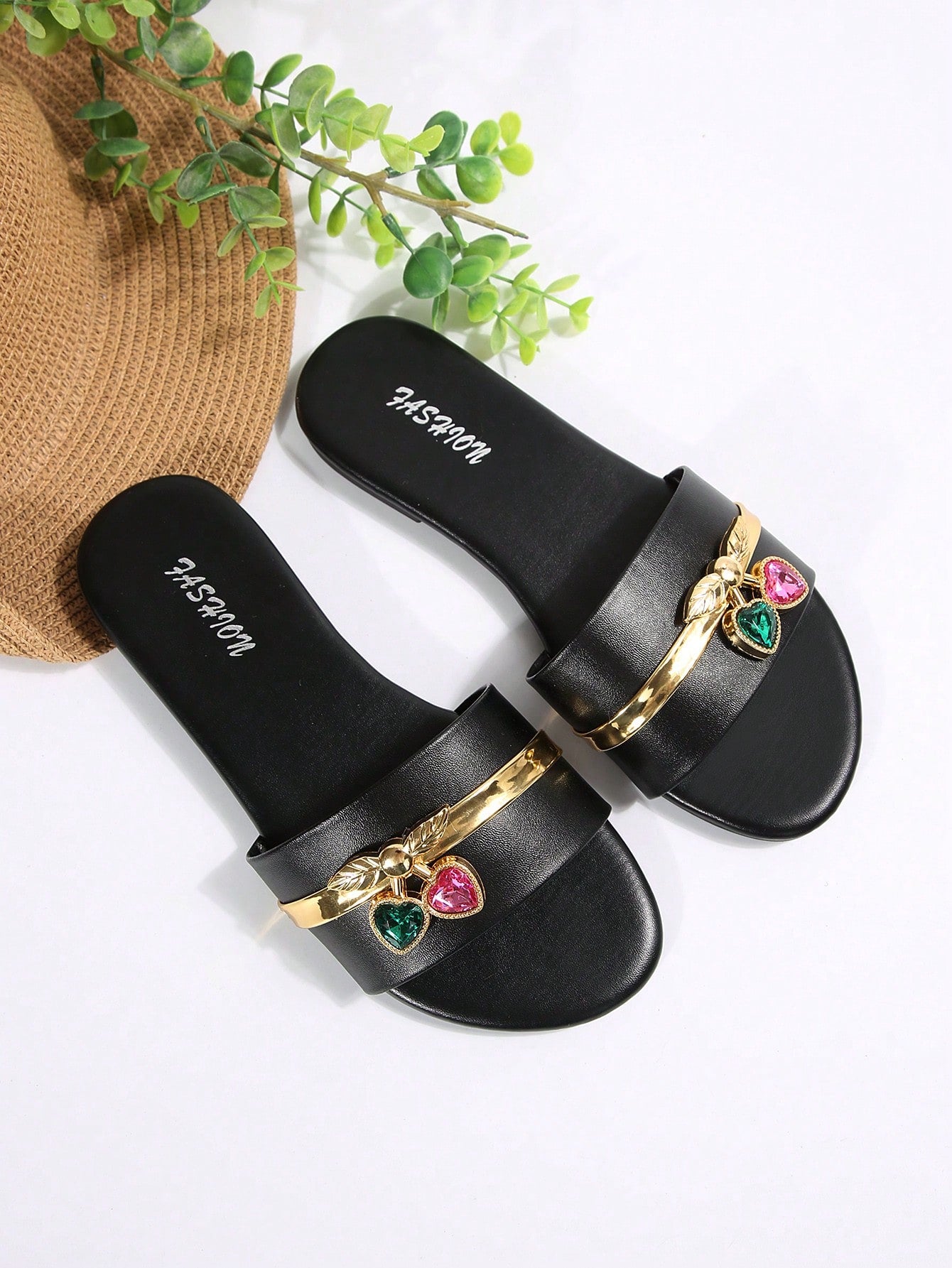 Pair of women's black flat slide sandals featuring rhinestone embellishments, metal accents, and a gold-strip detail on the upper, with an open-toe slip-on design.