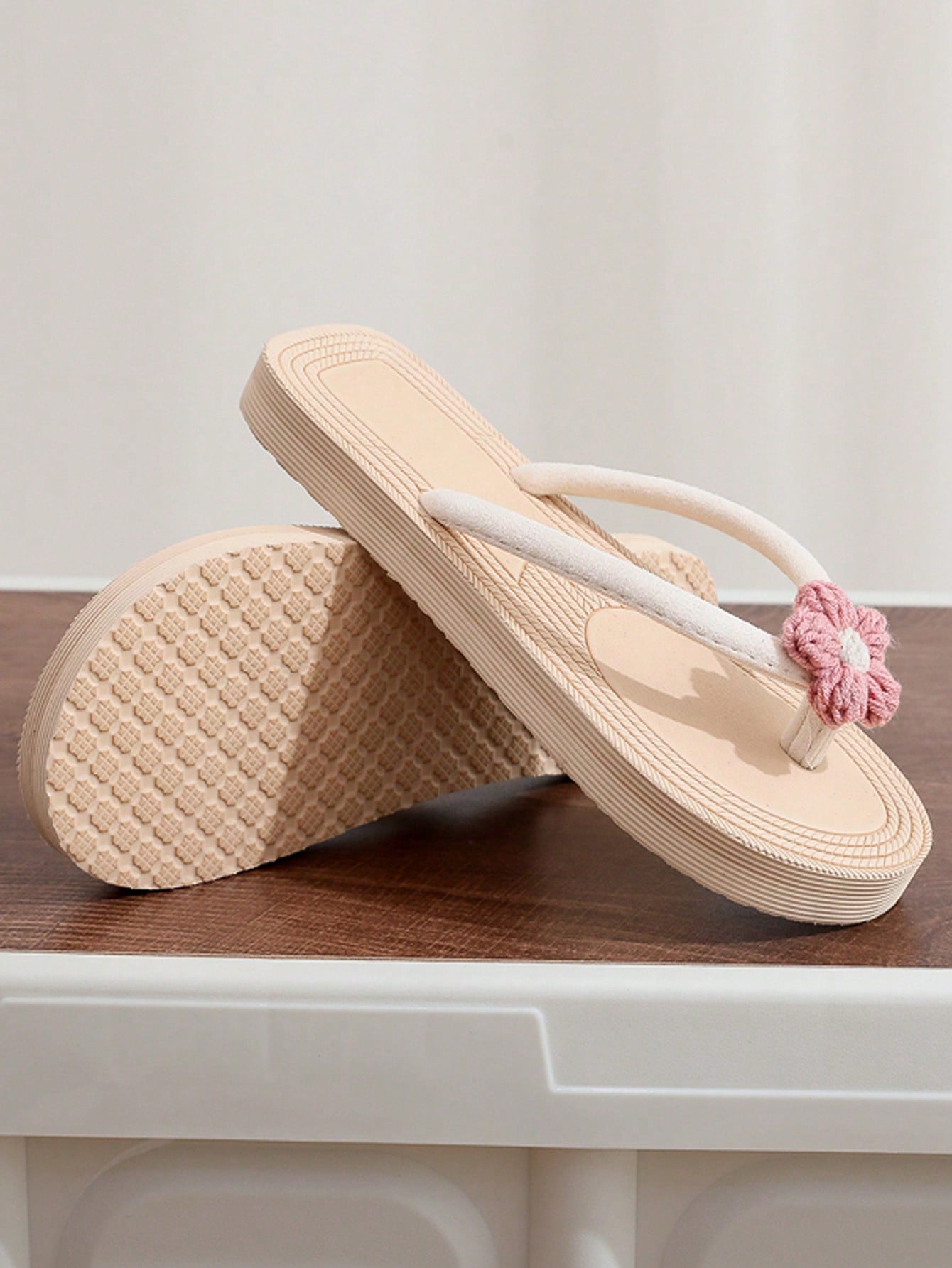 Women's casual flat thong flip flop sandals with minimalist design and applique detail, suitable for outdoor and beach holiday wear.
