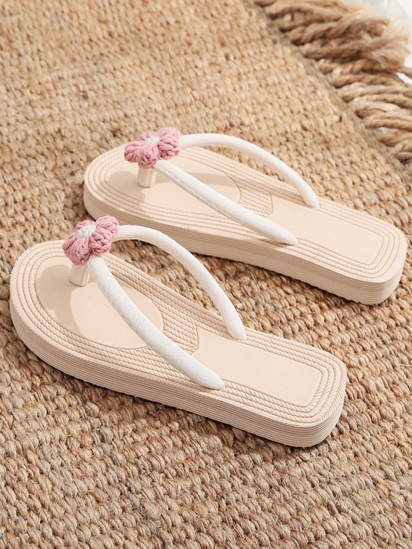 Women's casual flat thong flip flop sandals with minimalist design and applique detail, suitable for outdoor and beach holiday wear.