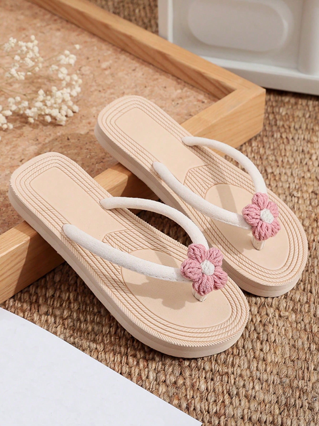 Women's casual flat thong flip flop sandals with minimalist design and applique detail, suitable for outdoor and beach holiday wear.