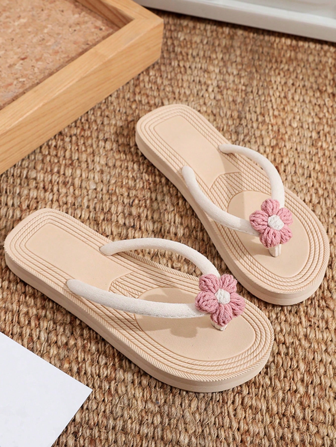 Women's casual flat thong flip flop sandals with minimalist design and applique detail, suitable for outdoor and beach holiday wear.