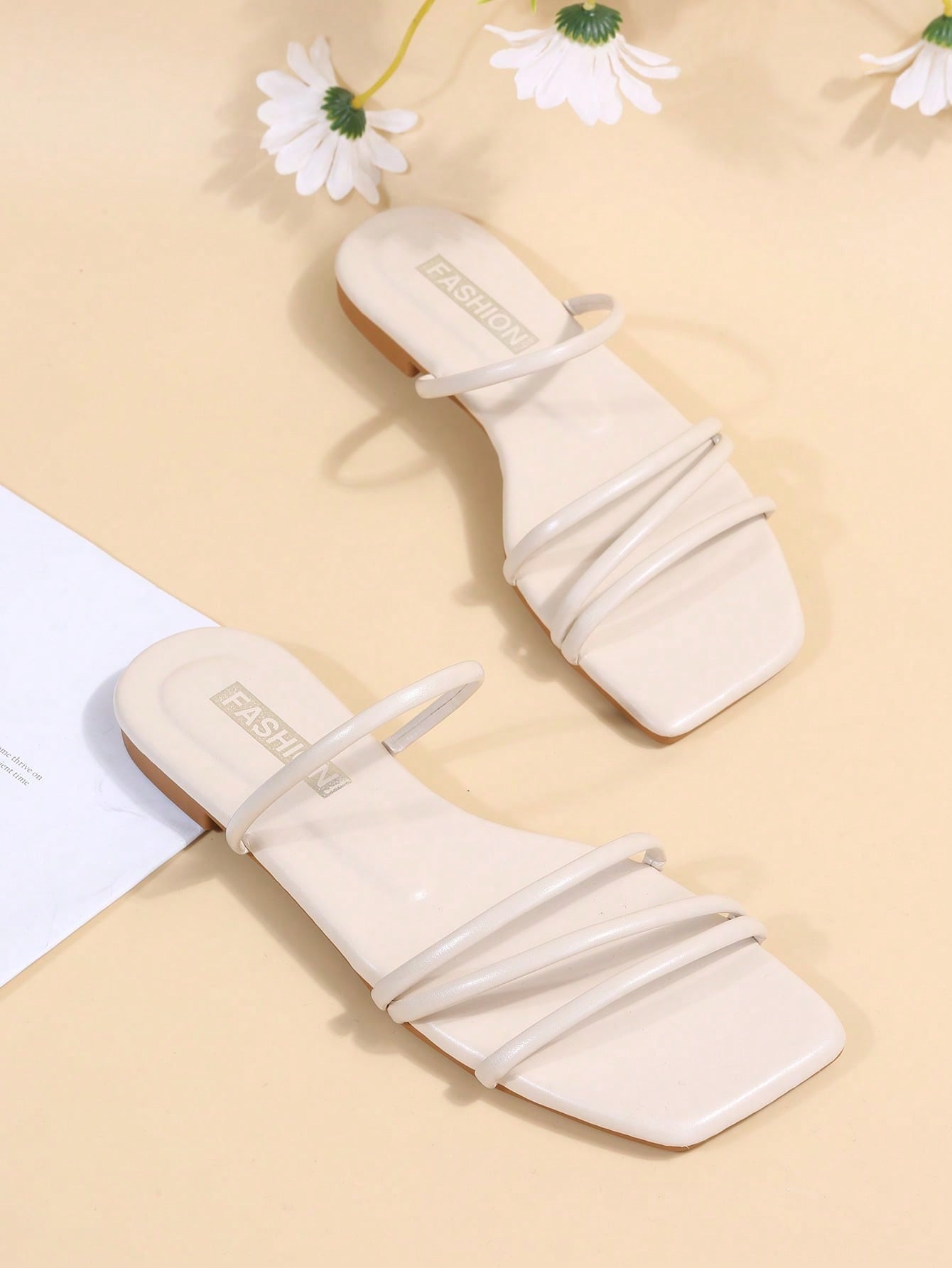 Casual striped flat slide sandals with beaded detail and open toe, beach-style slip-on design.