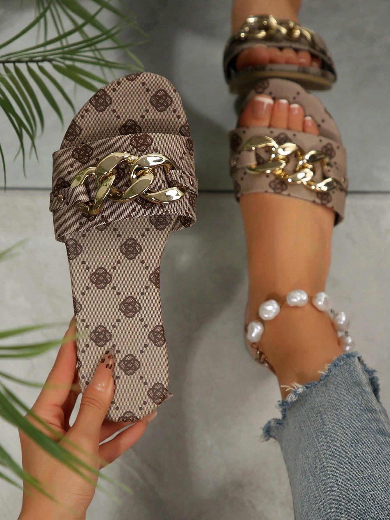 Pair of women's black flat slide sandals featuring rhinestone embellishments, metal accents, and a gold-strip detail on the upper, with an open-toe slip-on design.