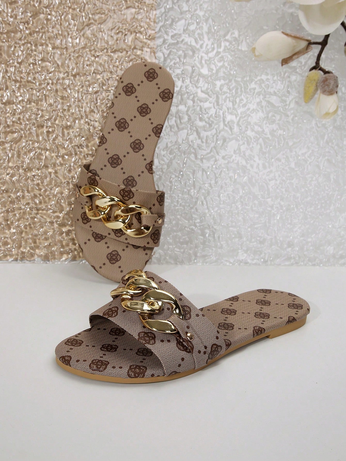 Pair of women's black flat slide sandals featuring rhinestone embellishments, metal accents, and a gold-strip detail on the upper, with an open-toe slip-on design.