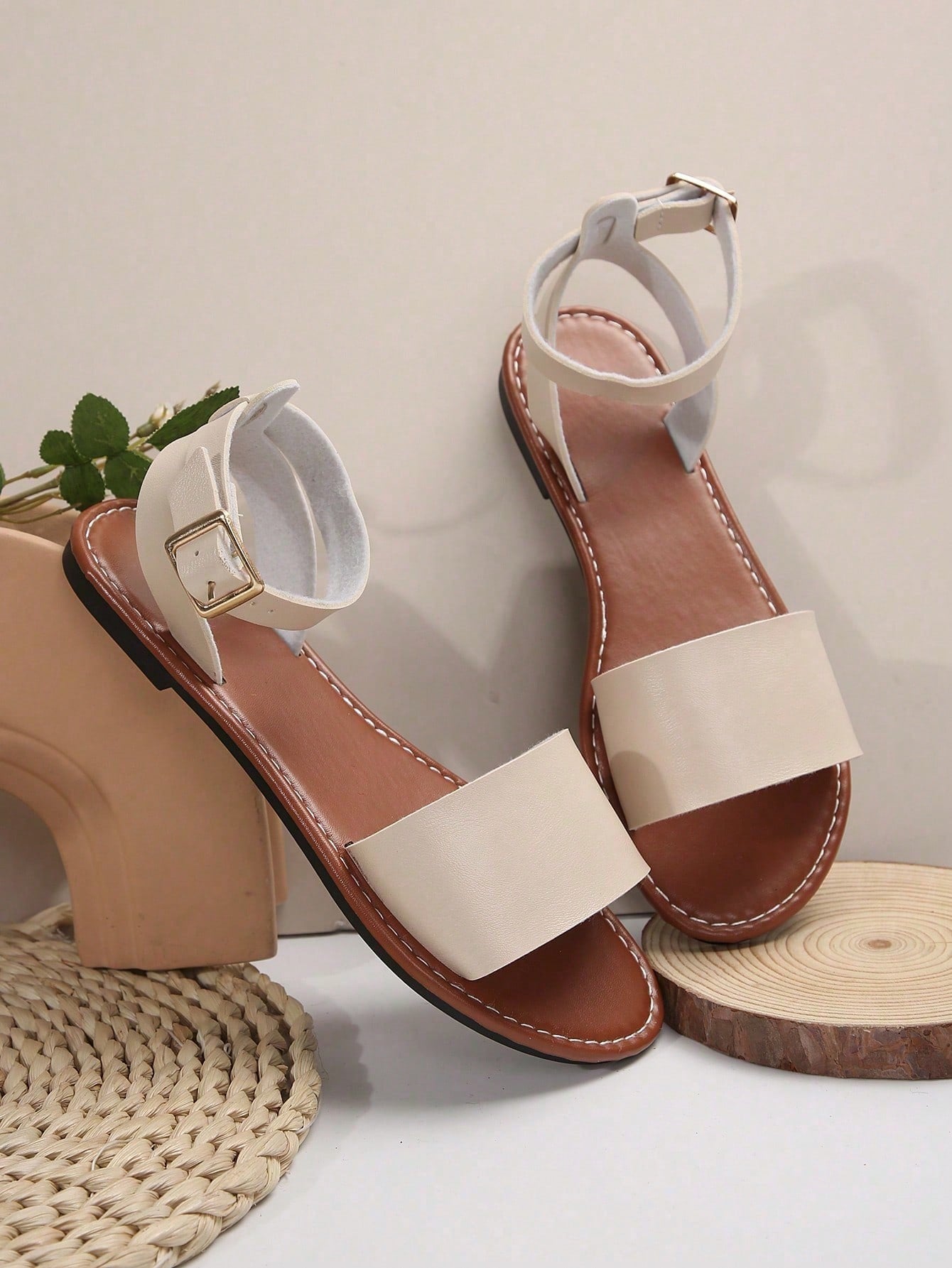Plus size women’s slip-on flat slide sandals with a plain design, hollow out detail, and PU leather upper, suitable for casual outdoor and summer wear.