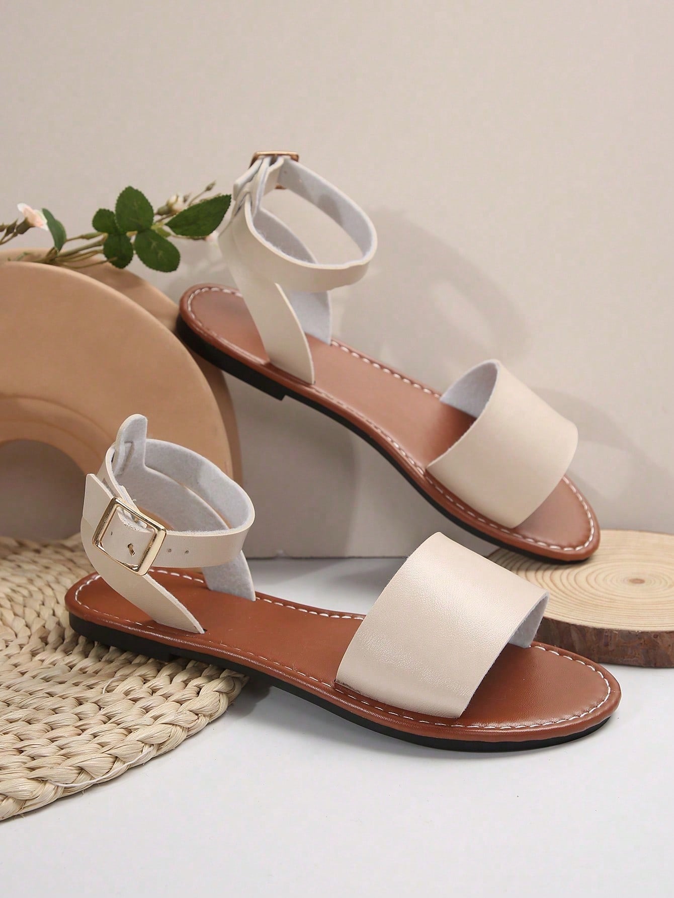 Plus size women’s slip-on flat slide sandals with a plain design, hollow out detail, and PU leather upper, suitable for casual outdoor and summer wear.