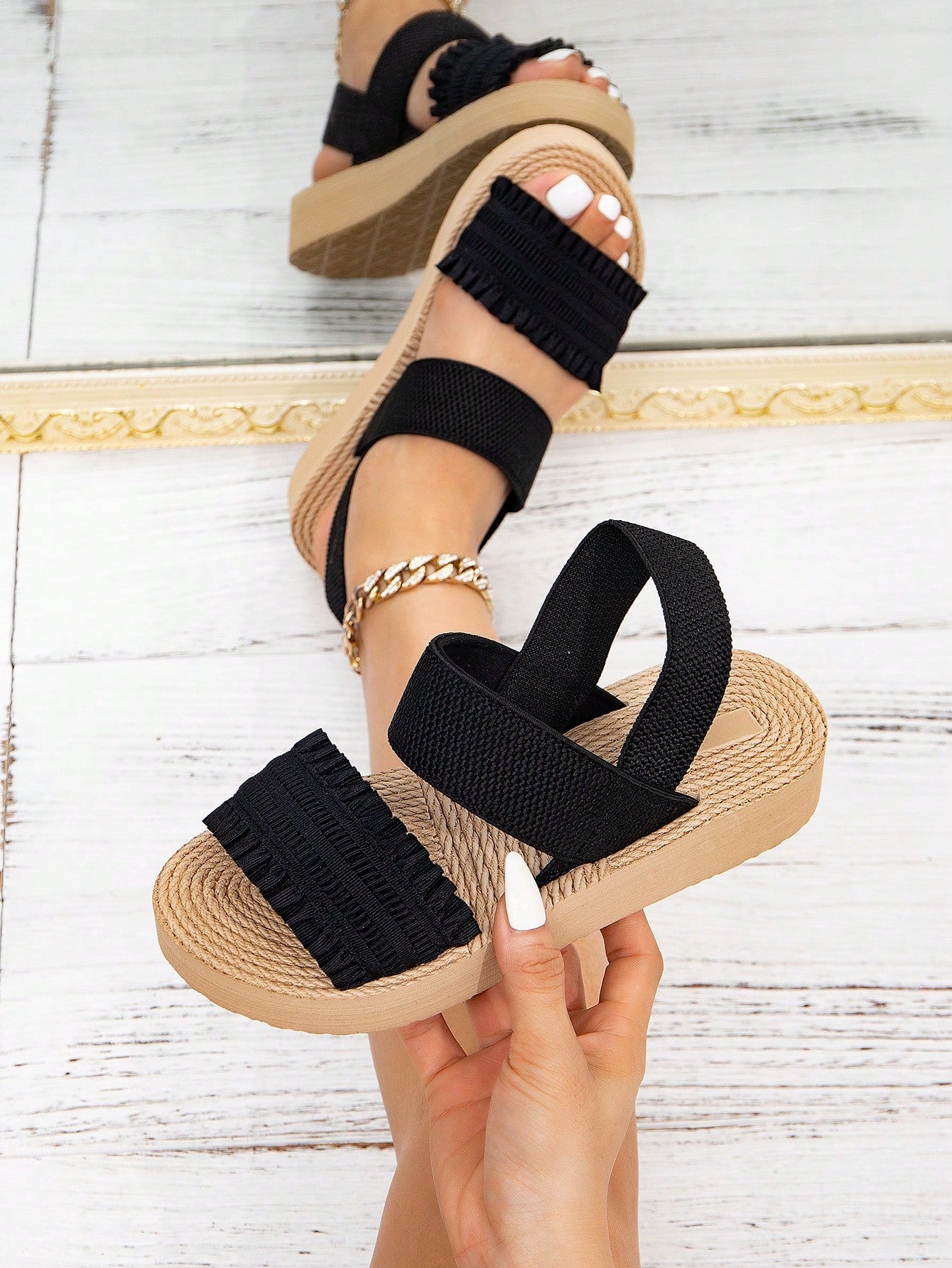 Women's black flat gladiator sandals with ruched and ruffle trim, textured fabric upper, and open-toe design for party, outdoor, and casual wear.