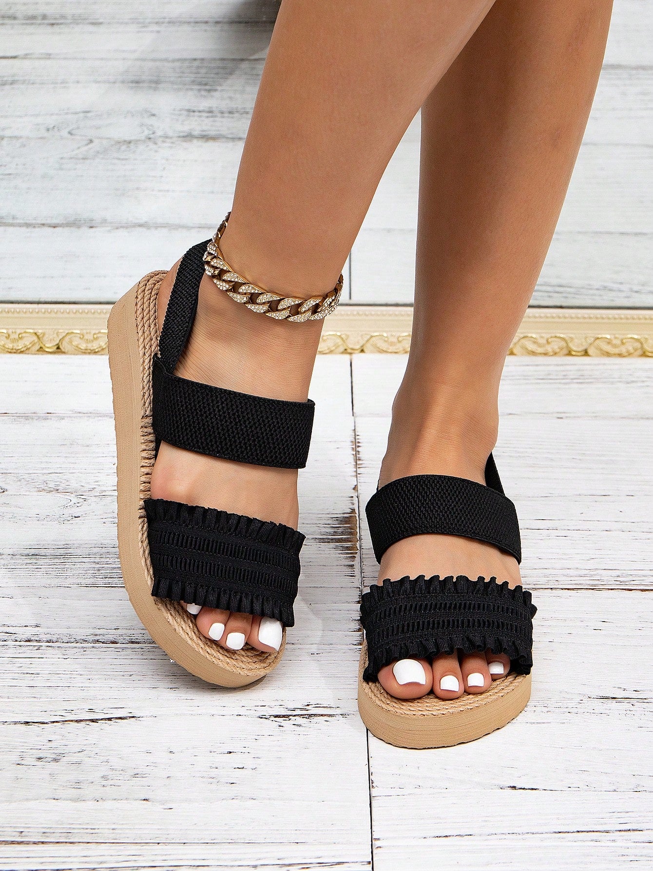 Women's black flat gladiator sandals with ruched and ruffle trim, textured fabric upper, and open-toe design for party, outdoor, and casual wear.