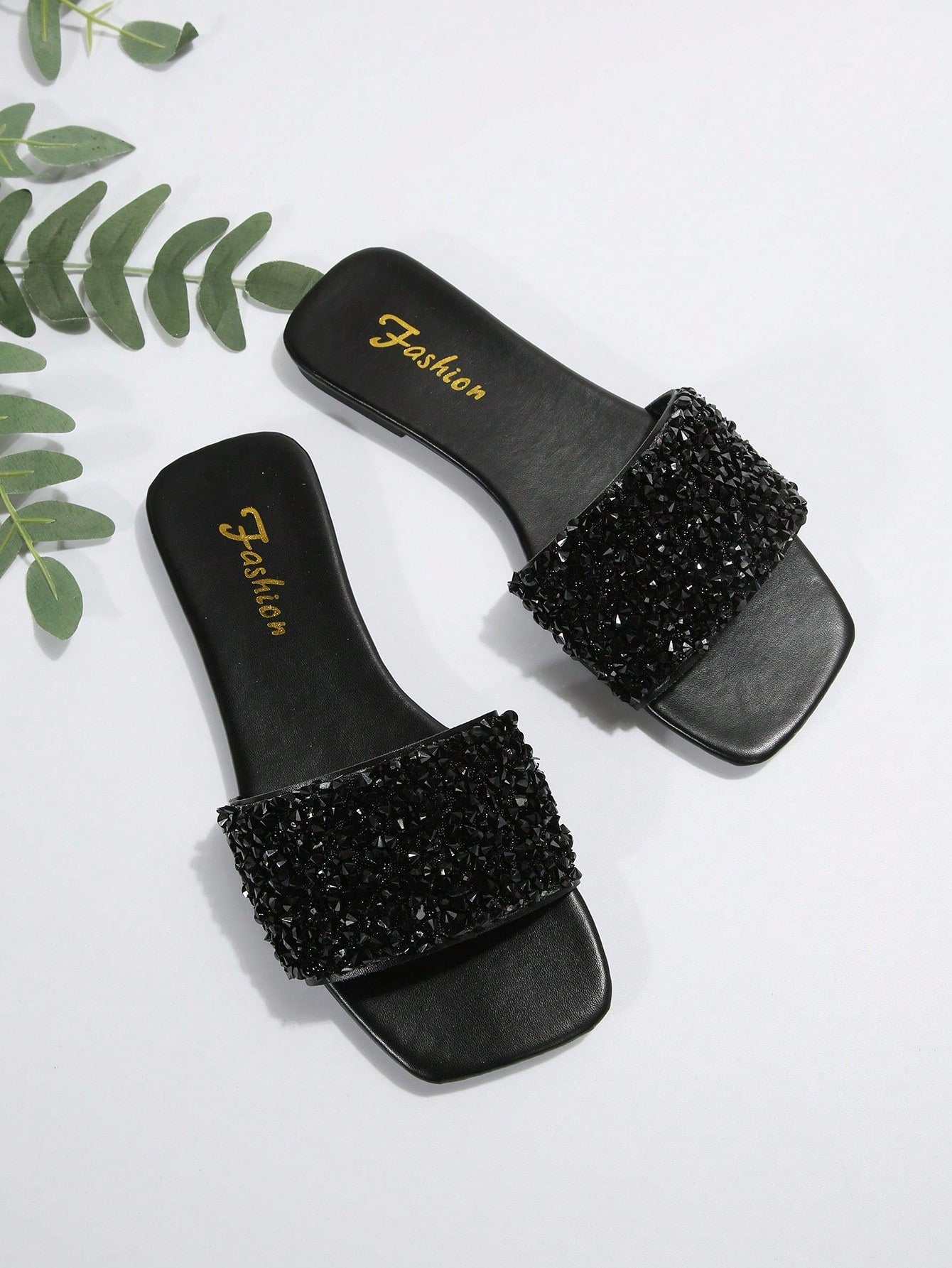 Black plus size women's slip-on flat slide sandals with square open toe, soft non-slip sole, and pearl rhinestone embellishments.
