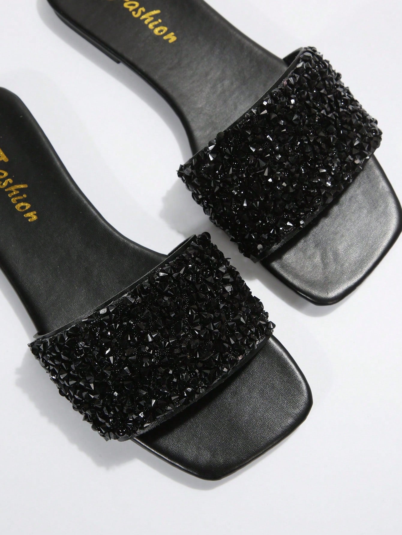Black plus size women's slip-on flat slide sandals with square open toe, soft non-slip sole, and pearl rhinestone embellishments.