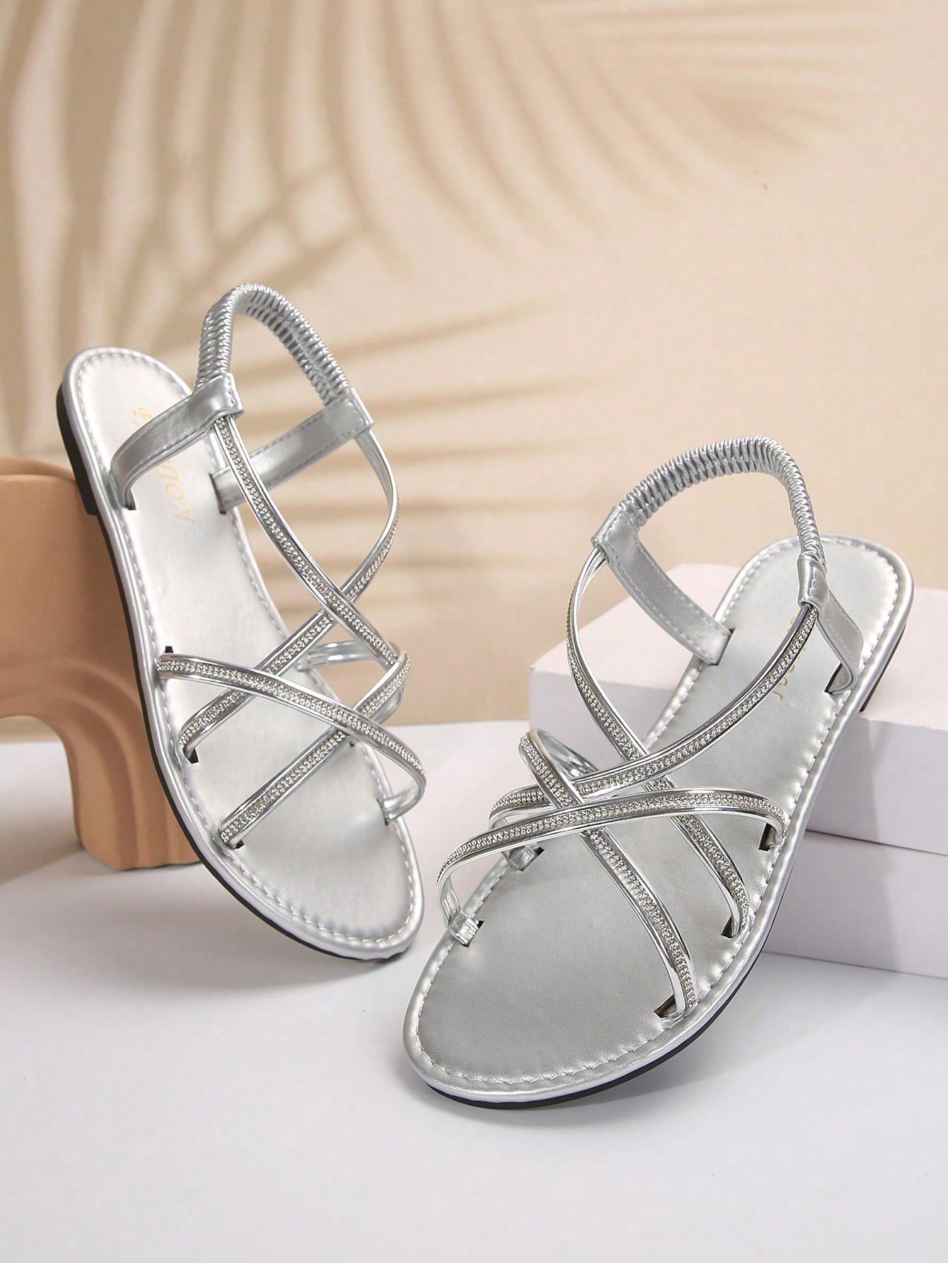 Women's plus size flat slide sandals with open toe, cross straps, rhinestone embellishment, and elastic band detail, suitable for casual beach and outdoor summer wear.