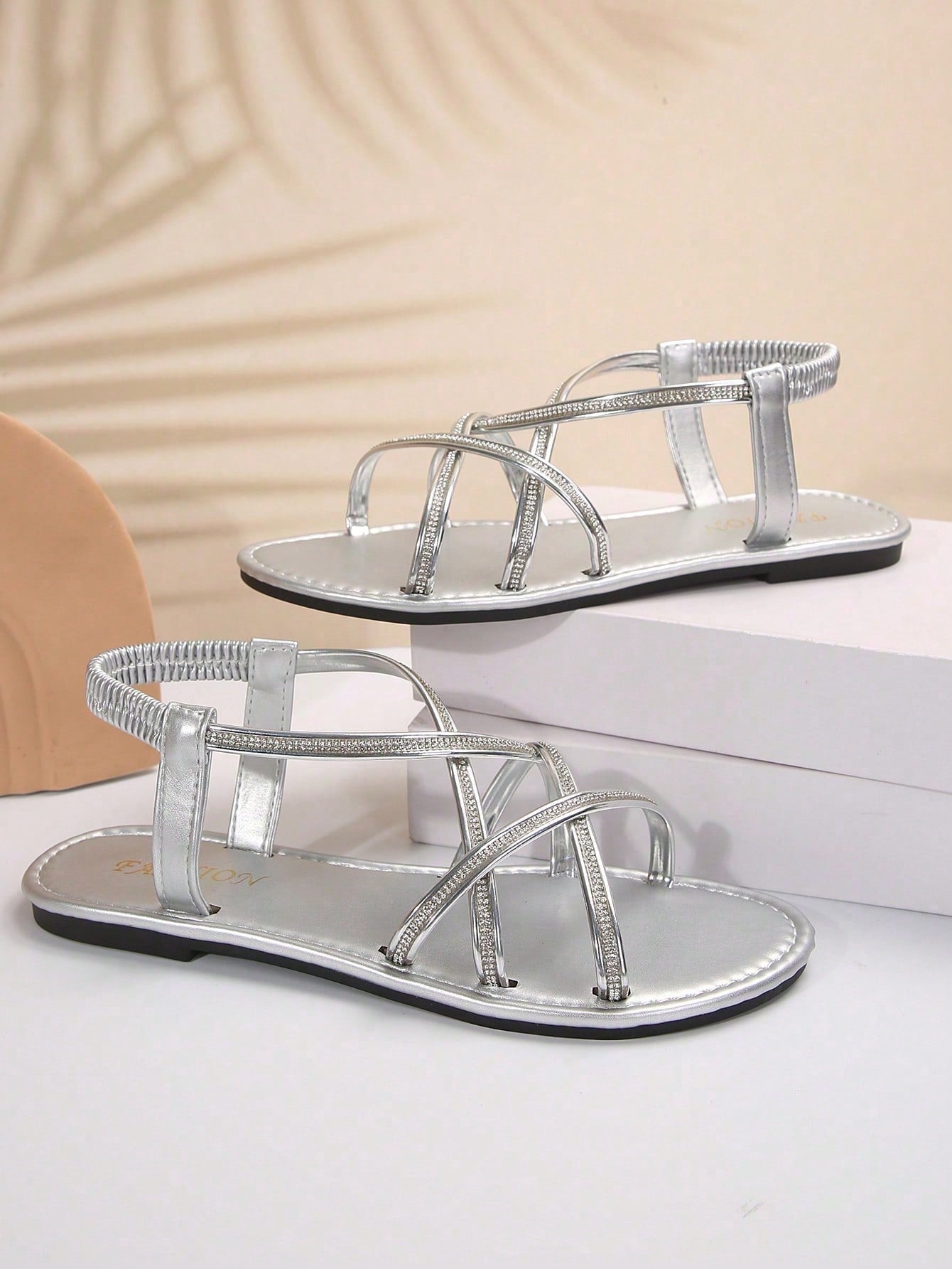 Women's plus size flat slide sandals with open toe, cross straps, rhinestone embellishment, and elastic band detail, suitable for casual beach and outdoor summer wear.
