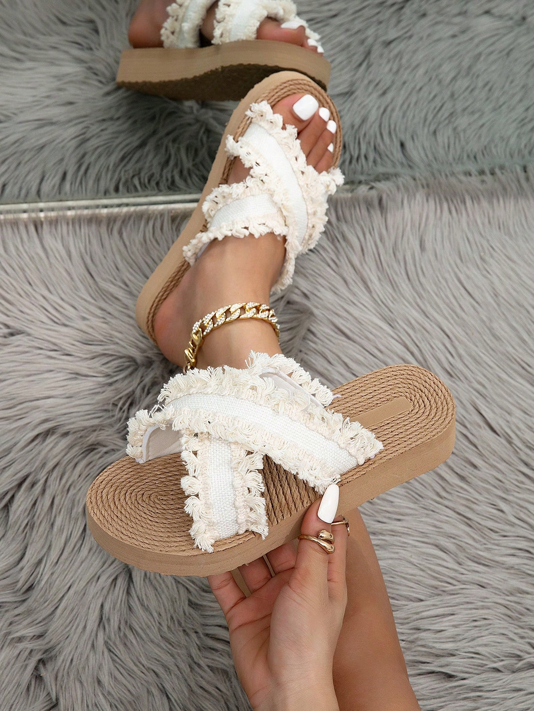 Women's beige platform low-heel wedge slide sandals with open toe, crisscross fabric straps, and fringe tassel detail