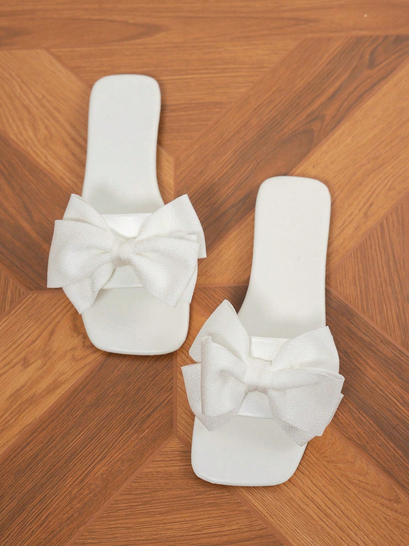 Women's flat slide sandals with a square open toe, geometric detail, and PU leather construction with rubber outsole.