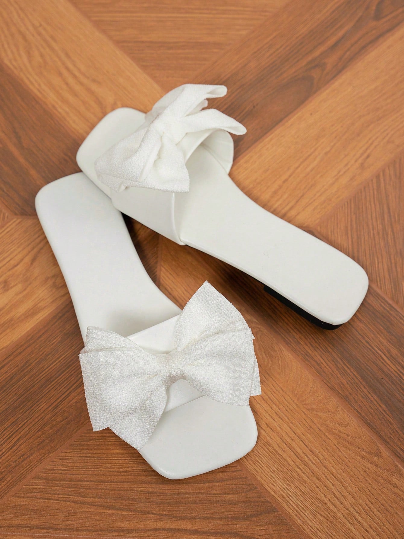 Women's flat slide sandals with a square open toe, geometric detail, and PU leather construction with rubber outsole.