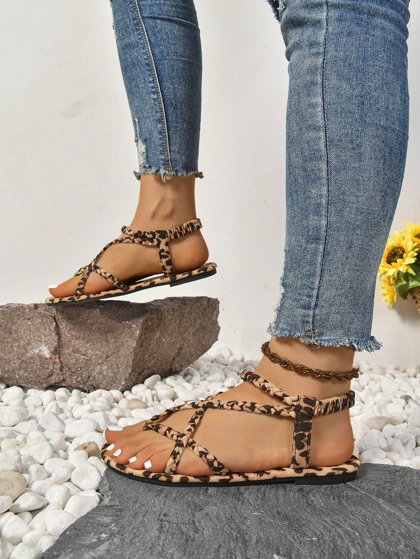 Women’s leopard print flat strappy sandals with peep toe/open toe design and braid detail, shown as summer outdoor footwear.
