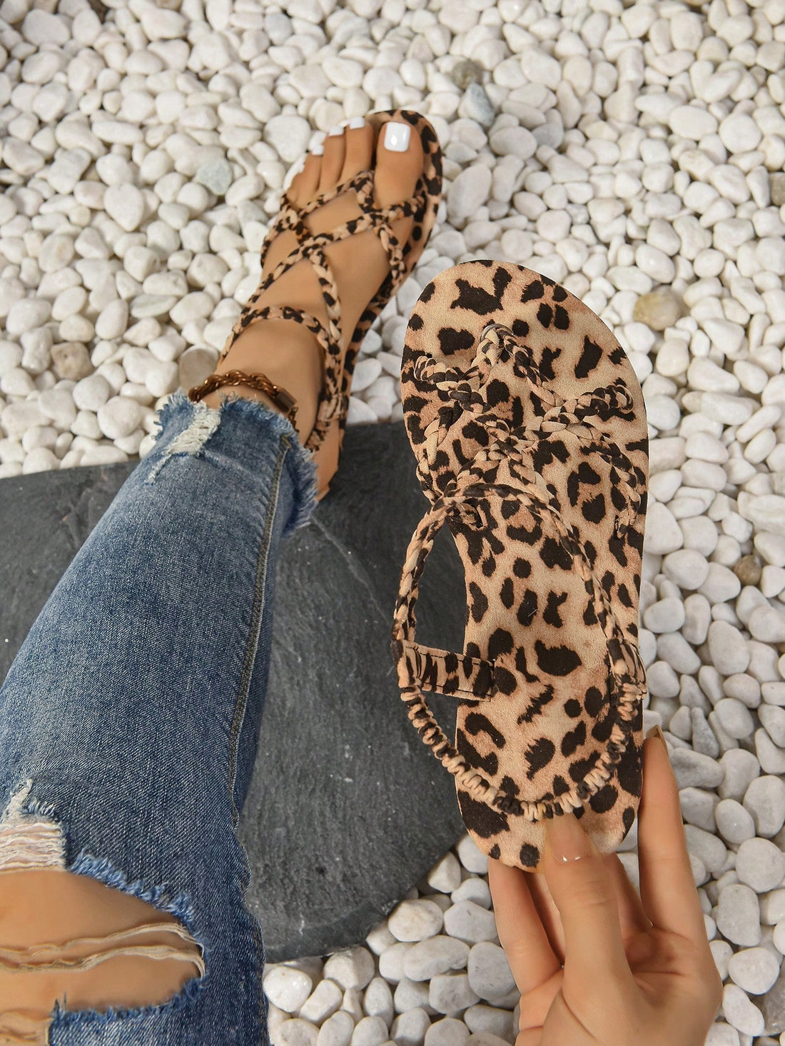 Women’s leopard print flat strappy sandals with peep toe/open toe design and braid detail, shown as summer outdoor footwear.