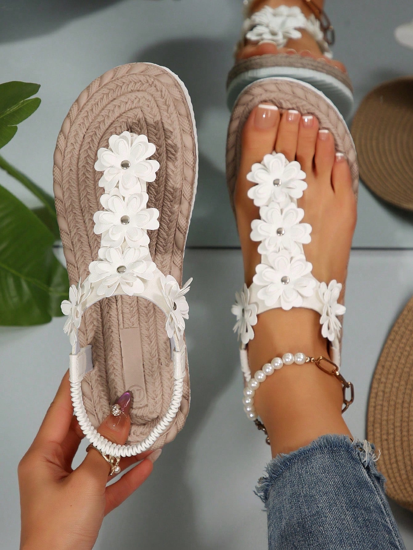 Women's white flat T-strap slip-on sandals with toe post and ditsy floral applique decoration