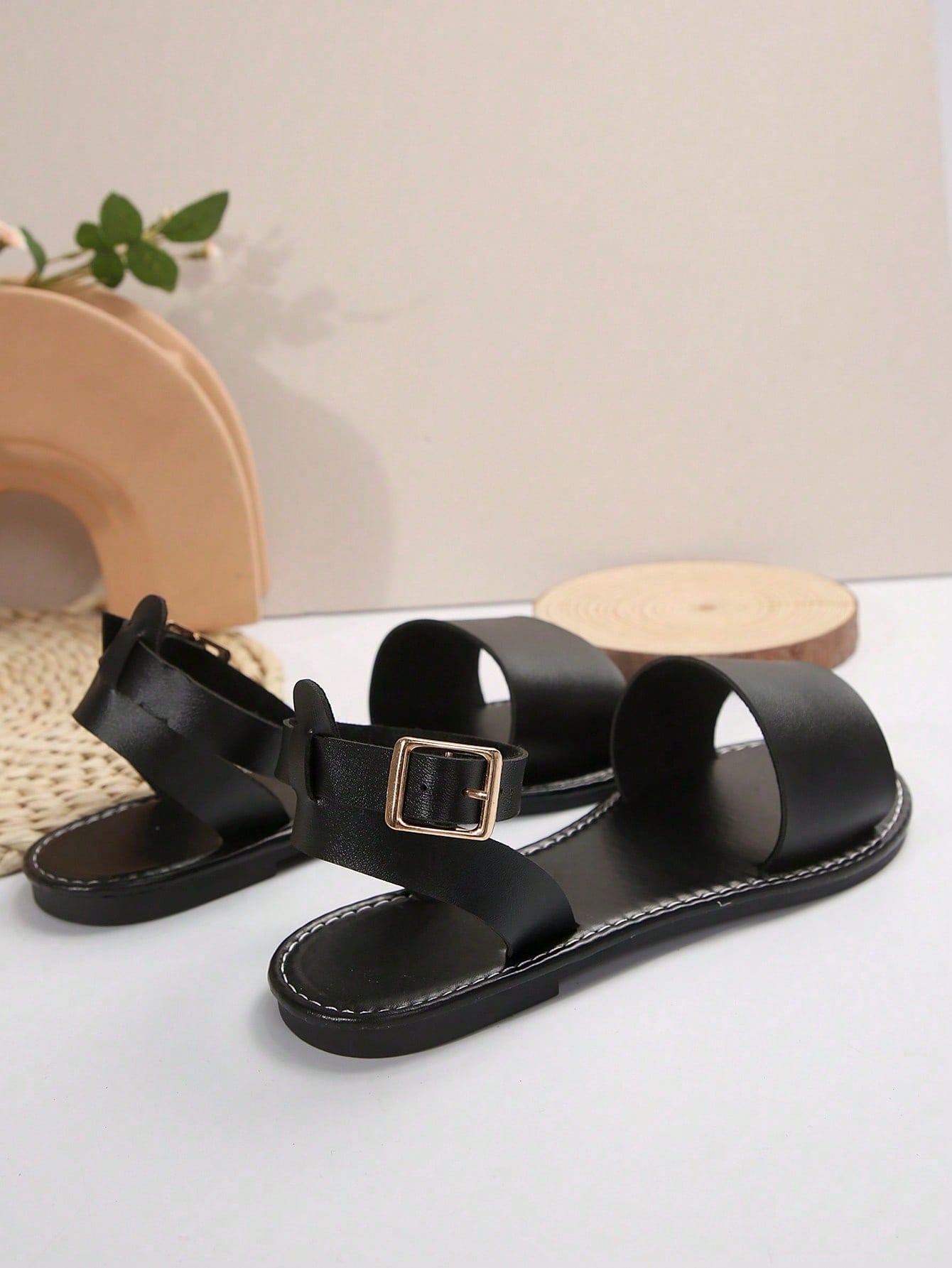Plus size women’s slip-on flat slide sandals with a plain design, hollow out detail, and PU leather upper, suitable for casual outdoor and summer wear.