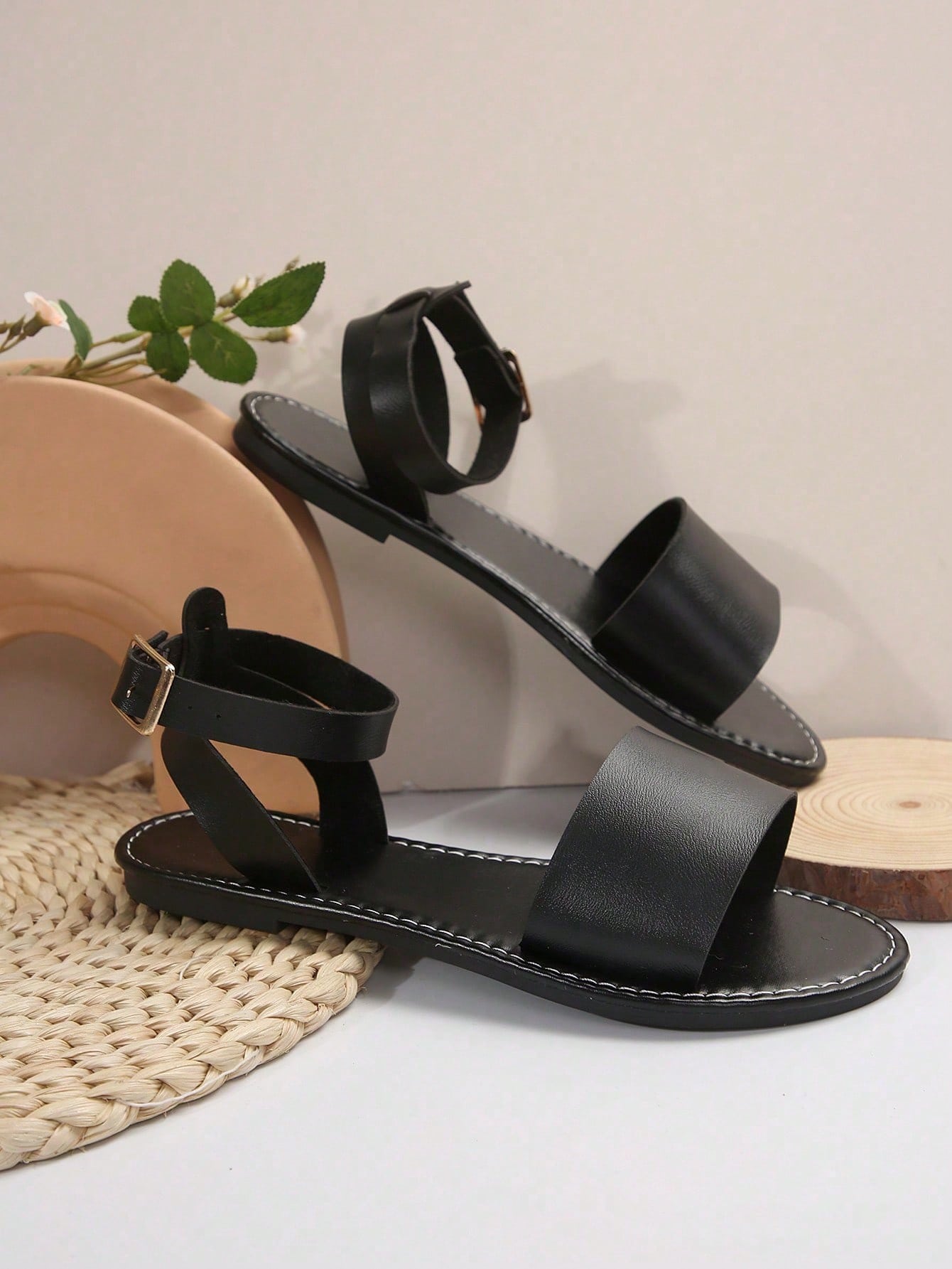 Plus size women’s slip-on flat slide sandals with a plain design, hollow out detail, and PU leather upper, suitable for casual outdoor and summer wear.