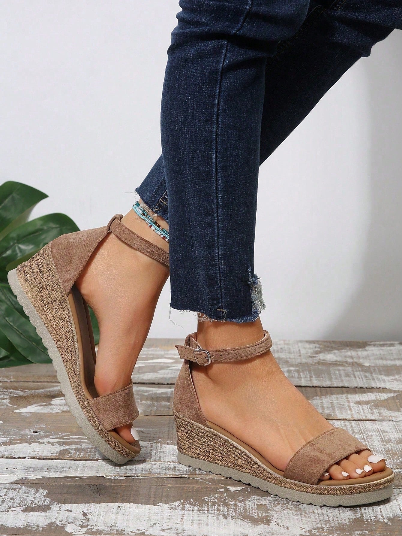 Women's classic wedge sandals featuring a peep open toe, ankle strap with buckle closure, mid wedge heel, and large bow detail in a bohemian beach style.