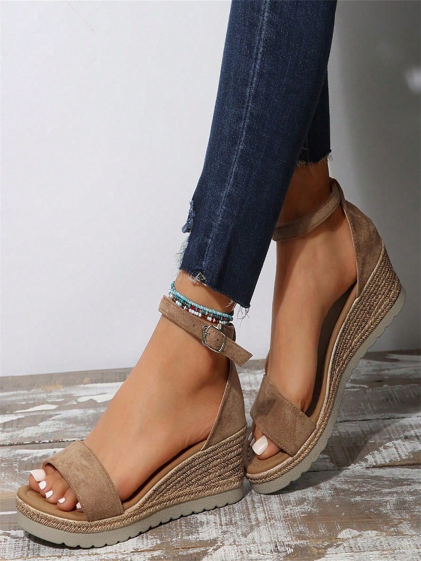 Women's classic wedge sandals featuring a peep open toe, ankle strap with buckle closure, mid wedge heel, and large bow detail in a bohemian beach style.