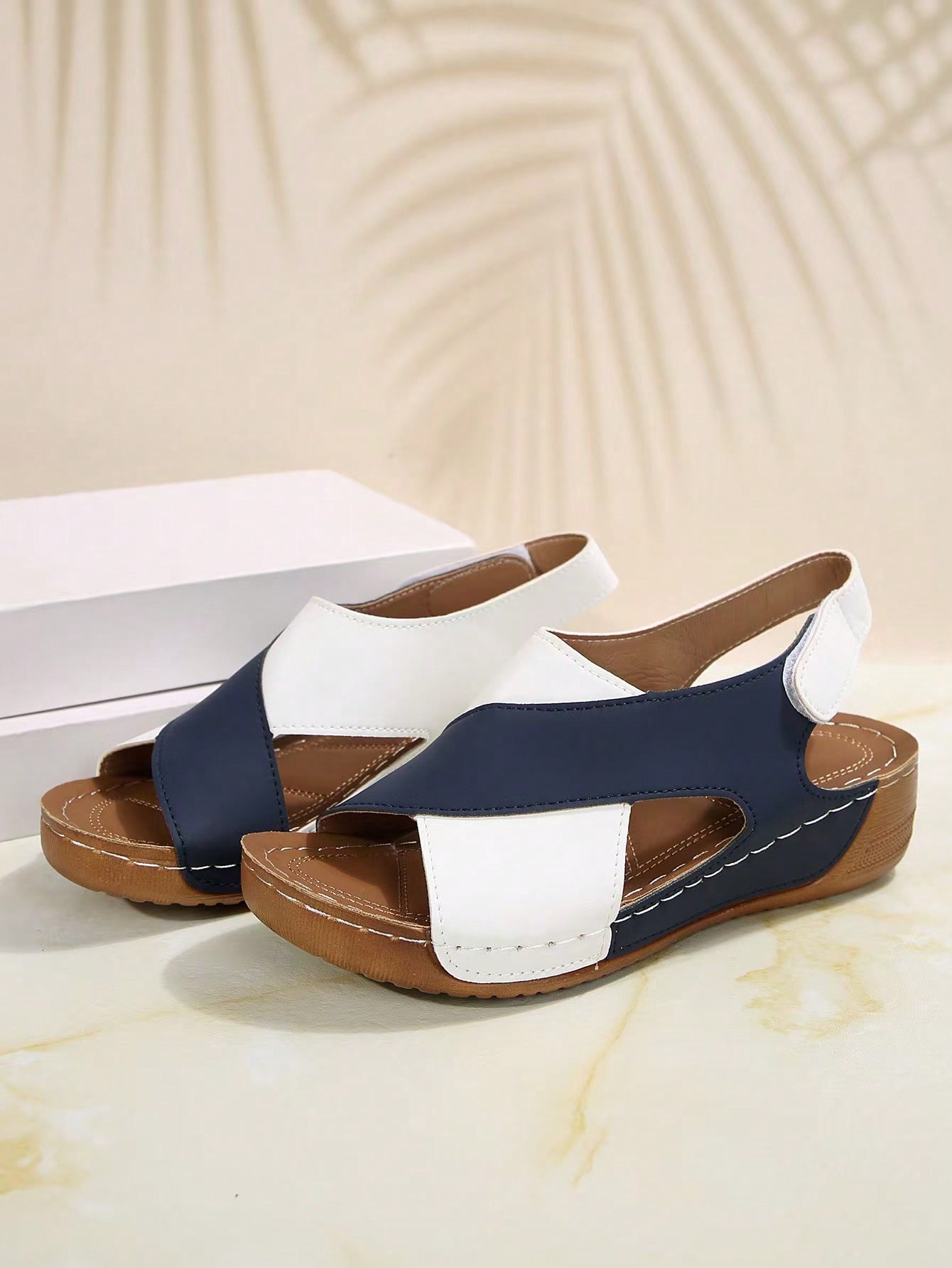 Women's color block platform flat sandals with open toe, criss-cross straps, and hook-loop closure, featuring a low heel thick sole design for casual vacation wear.