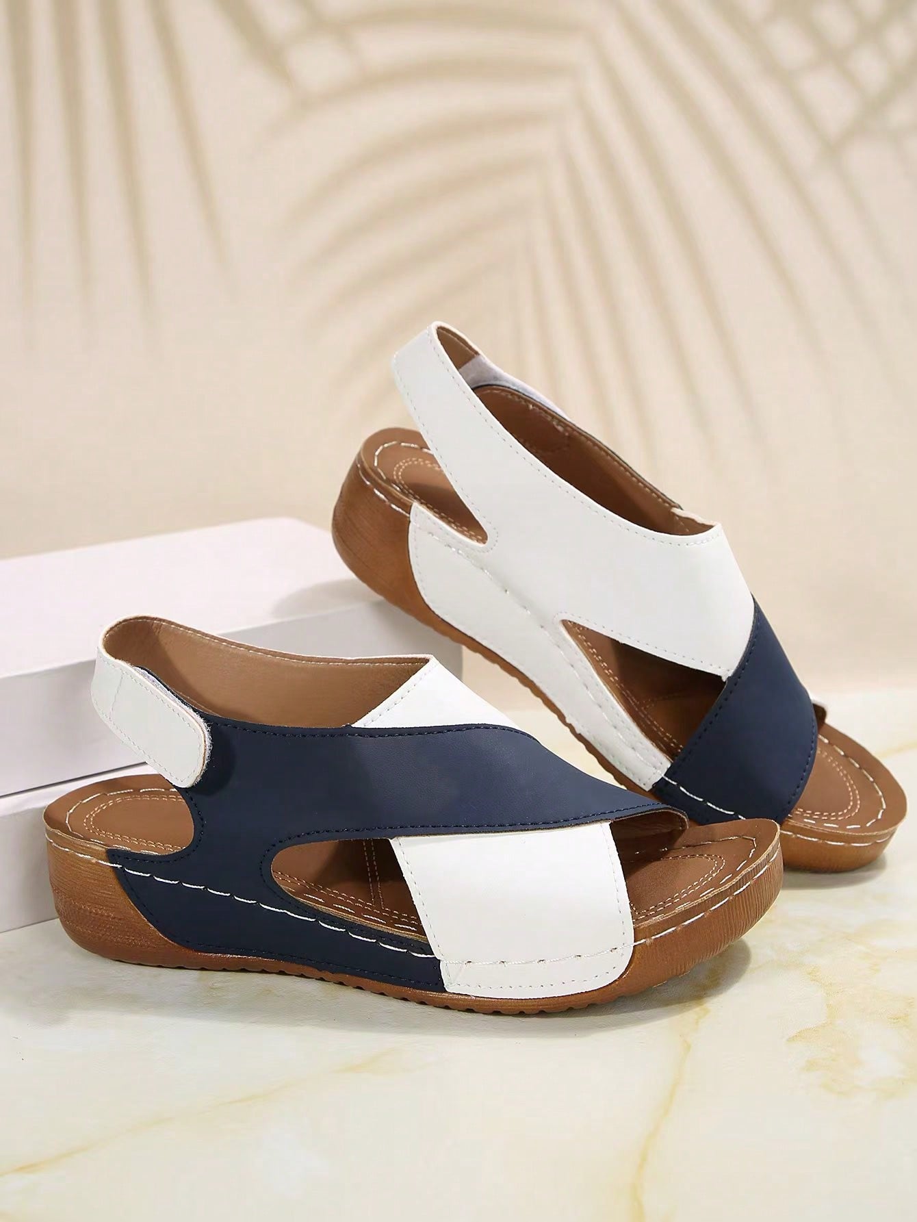 Women's color block platform flat sandals with open toe, criss-cross straps, and hook-loop closure, featuring a low heel thick sole design for casual vacation wear.