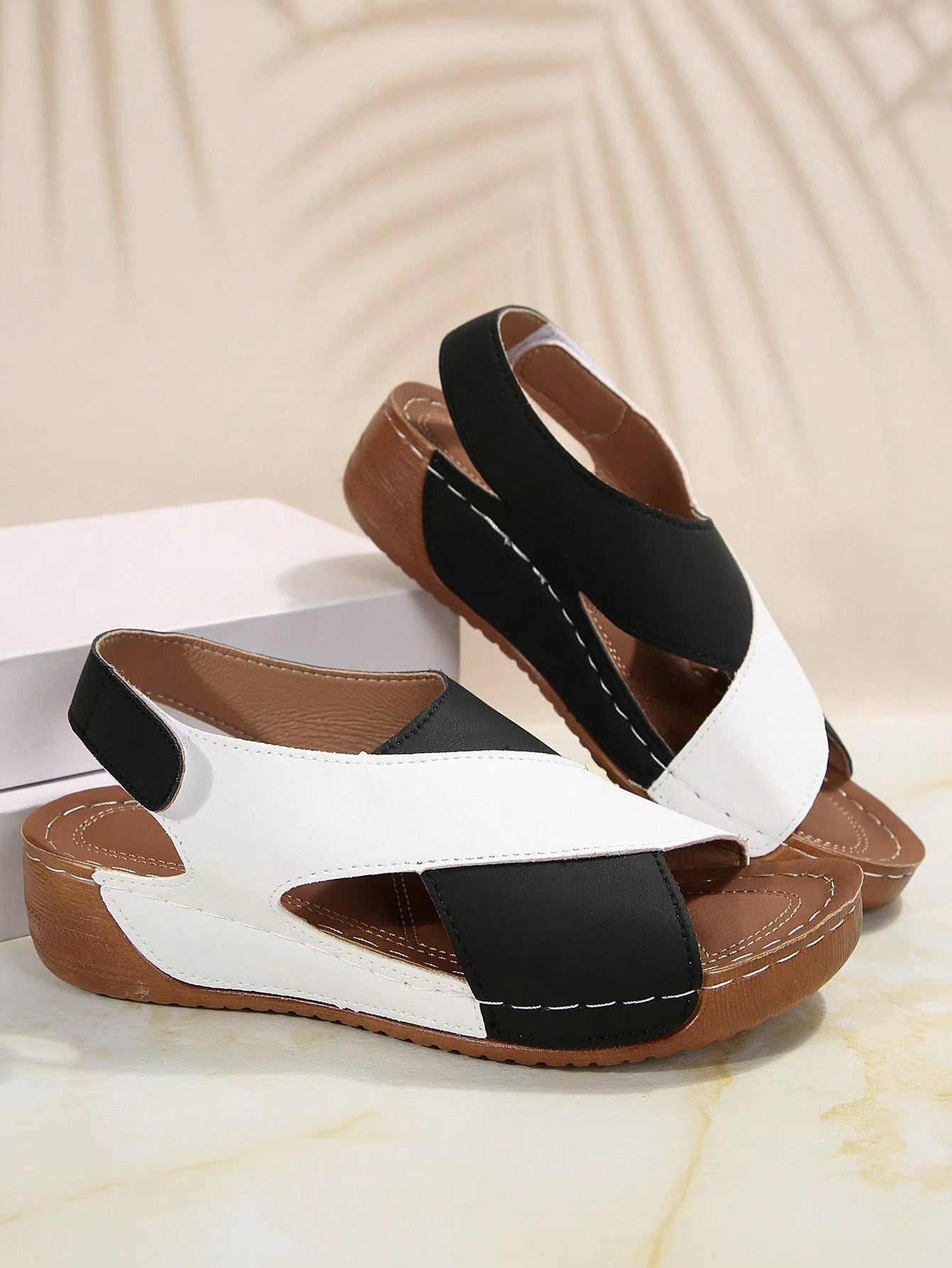 Women's color block platform flat sandals with open toe, criss-cross straps, and hook-loop closure, featuring a low heel thick sole design for casual vacation wear.
