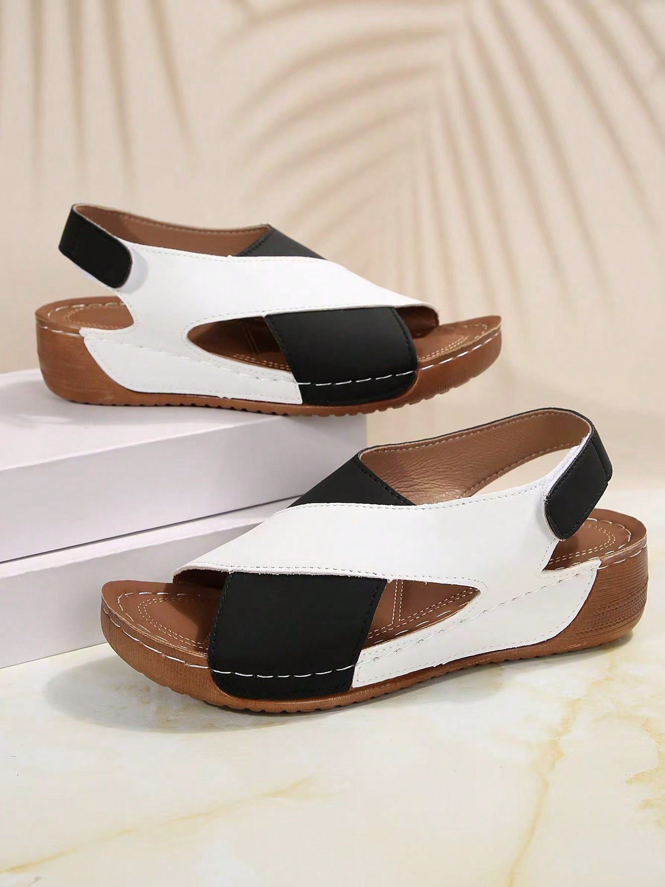 Women's color block platform flat sandals with open toe, criss-cross straps, and hook-loop closure, featuring a low heel thick sole design for casual vacation wear.