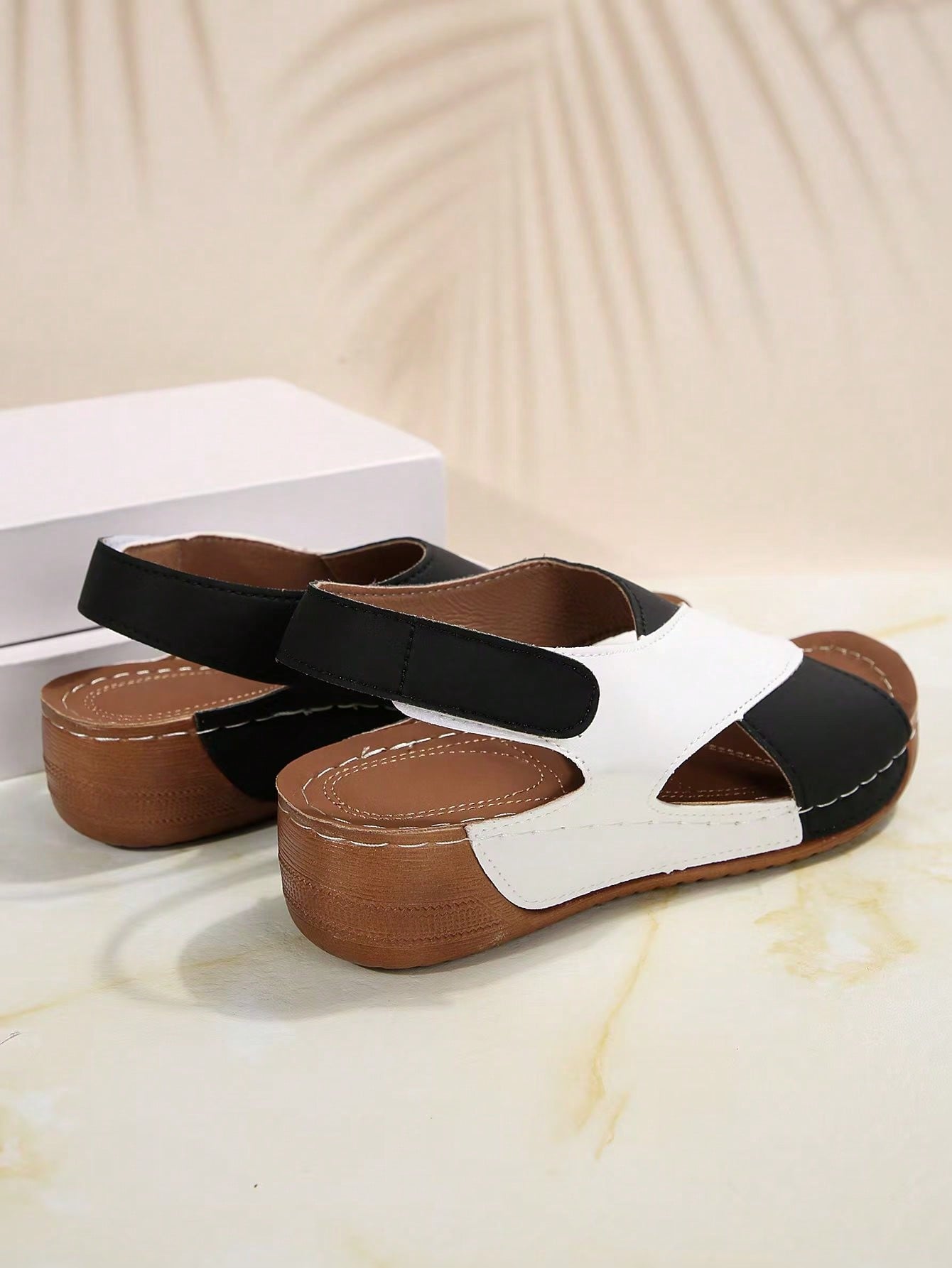 Women's color block platform flat sandals with open toe, criss-cross straps, and hook-loop closure, featuring a low heel thick sole design for casual vacation wear.