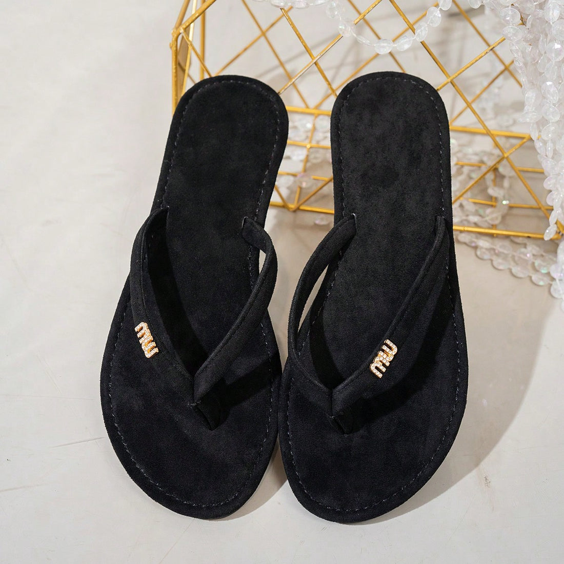 Women's flat flip-flops with rhinestone and letter detail, designed for casual travel, home wear, and outdoor use.