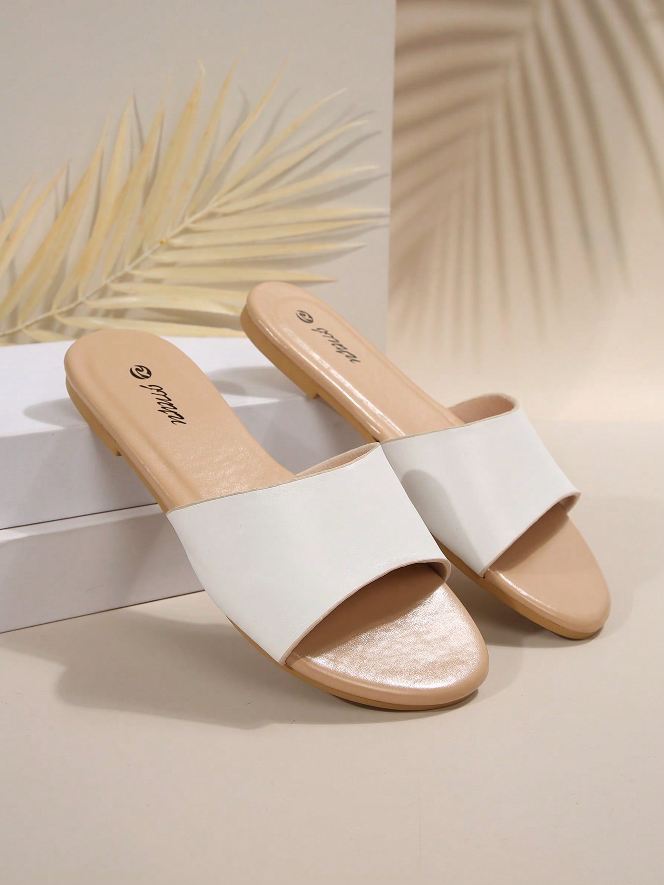 Pair of women's black flat slide sandals featuring rhinestone embellishments, metal accents, and a gold-strip detail on the upper, with an open-toe slip-on design.