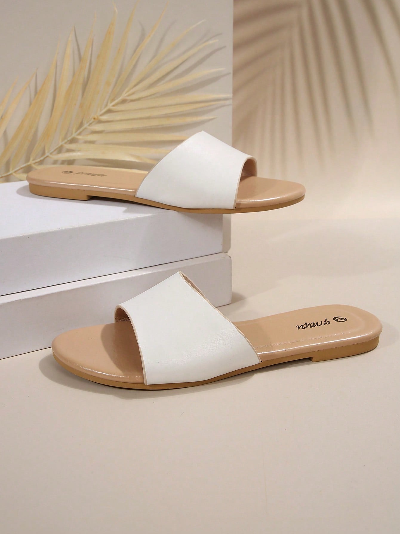 Pair of women's black flat slide sandals featuring rhinestone embellishments, metal accents, and a gold-strip detail on the upper, with an open-toe slip-on design.