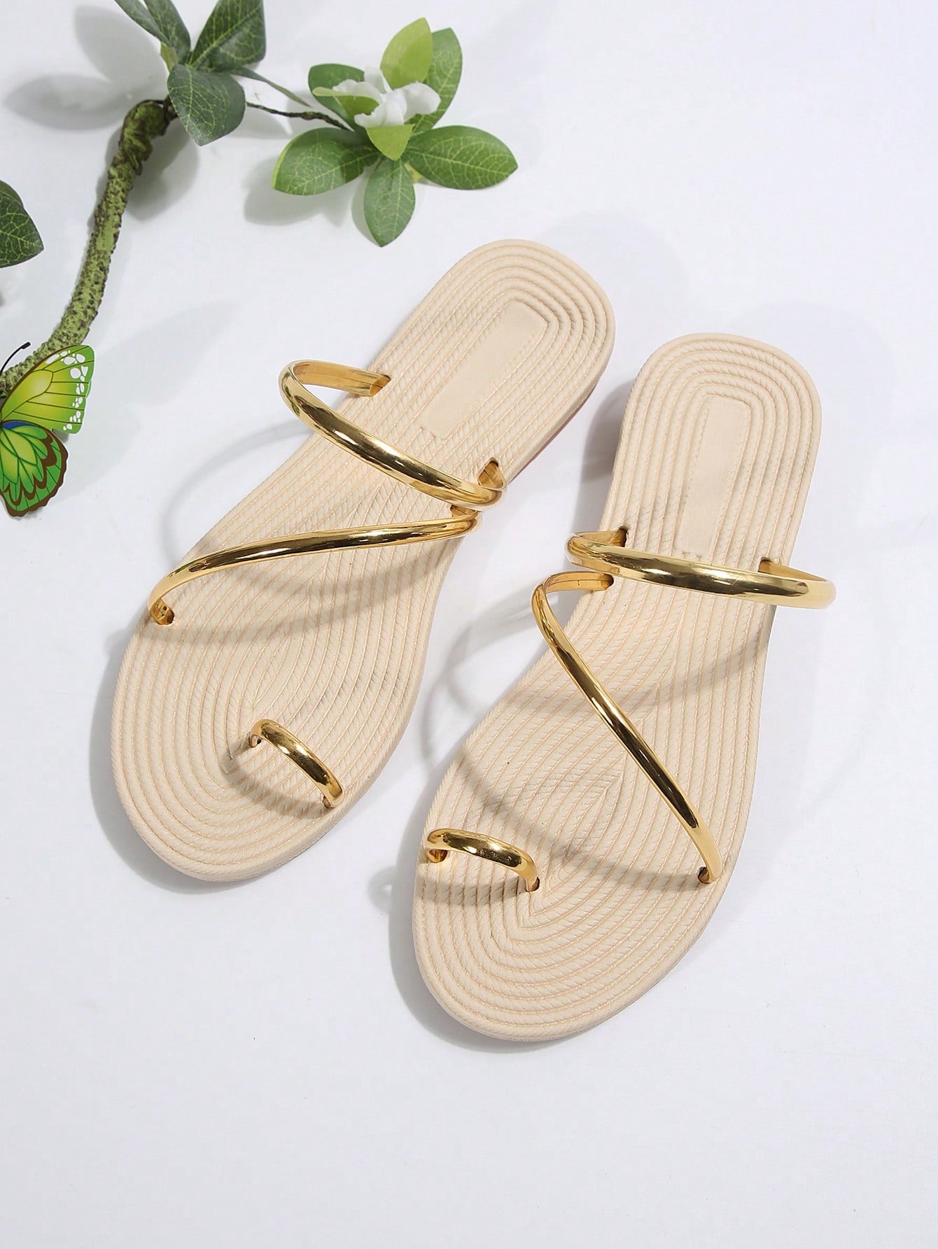 Women's gold flat slide sandals with bow detail, round toe shape, and toe-post thong design in a lightweight slip-on style.