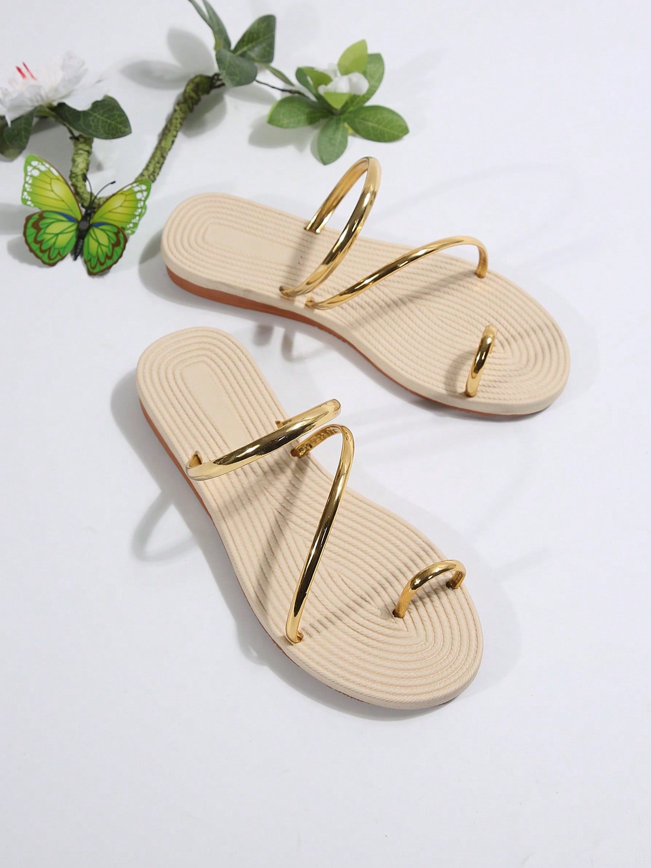 Women's gold flat slide sandals with bow detail, round toe shape, and toe-post thong design in a lightweight slip-on style.