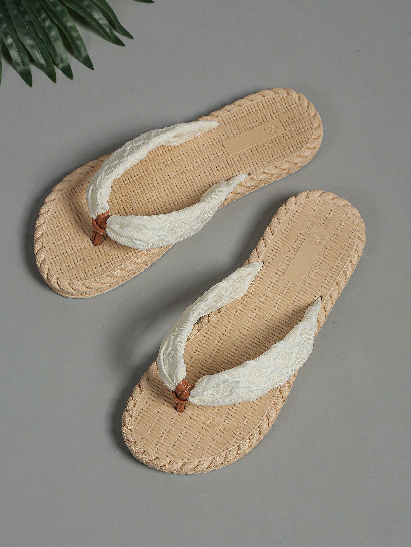 White women's flat sandals with cloud-inspired colorblock and tropical pattern, featuring braided woven-look straps and a casual beach style.