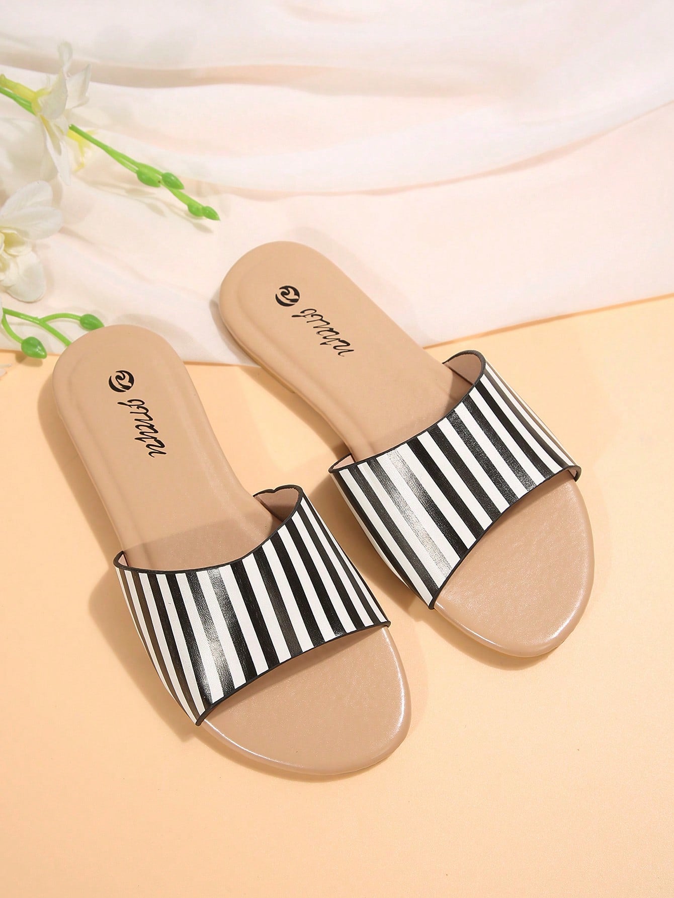 Pair of women's black flat slide sandals featuring rhinestone embellishments, metal accents, and a gold-strip detail on the upper, with an open-toe slip-on design.