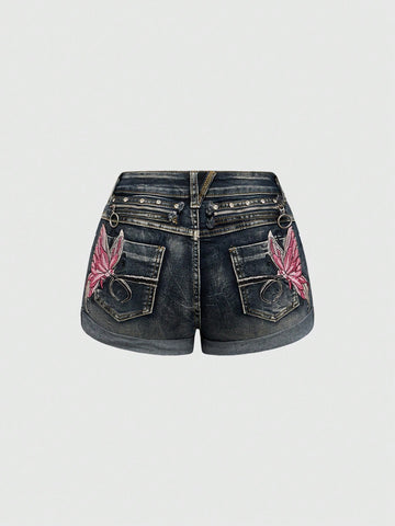 Blue washed shorts with butterfly embroidery, distressed detailing, ultra low waist, button closure, zipper fly, and pockets.