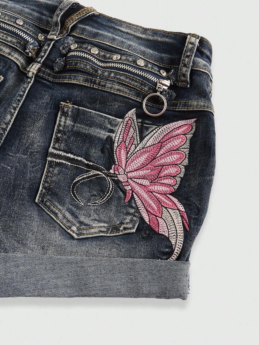Blue washed shorts with butterfly embroidery, distressed detailing, ultra low waist, button closure, zipper fly, and pockets.