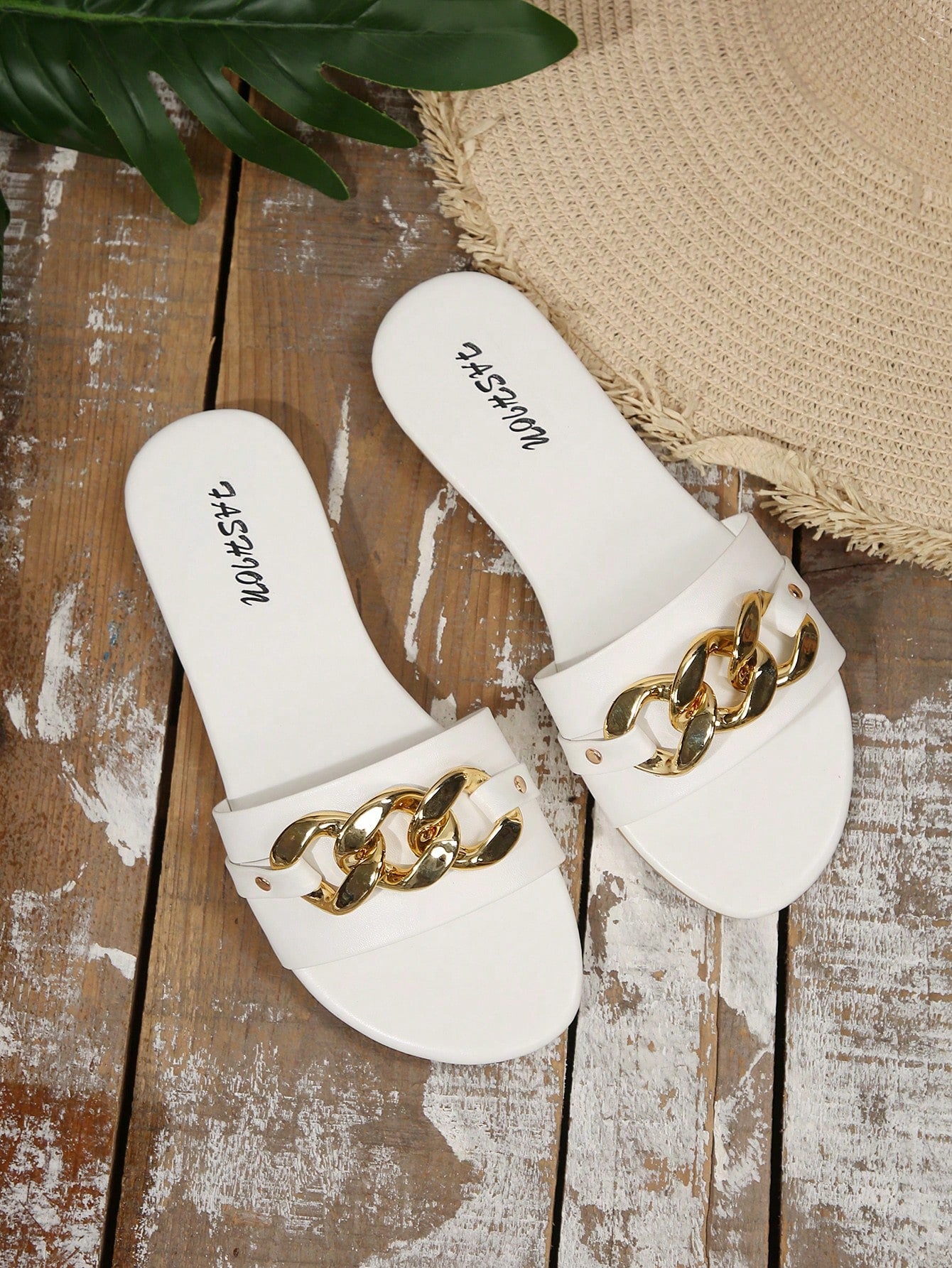 Pair of women's black flat slide sandals featuring rhinestone embellishments, metal accents, and a gold-strip detail on the upper, with an open-toe slip-on design.