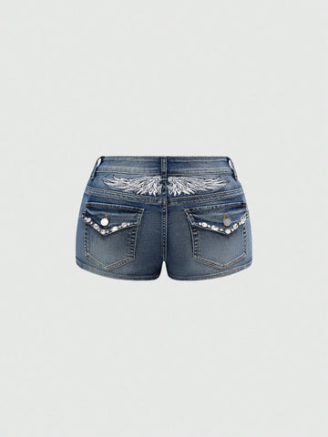 Blue ultra low waist mini shorts with ripped details, zipper fly, button closure, back wing embroidery, and rhinestone decor in a Y2K grunge punk style.